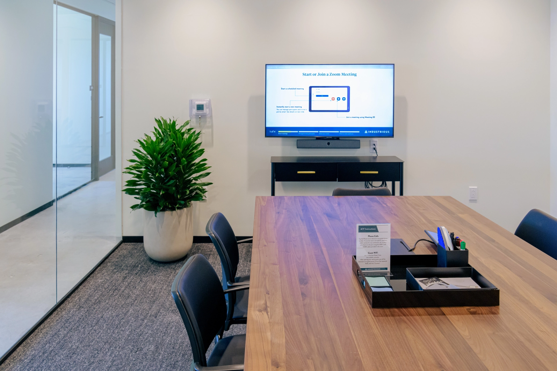 A meeting room in West Palm Beach with a TV on the wall for collaborative workspace.
