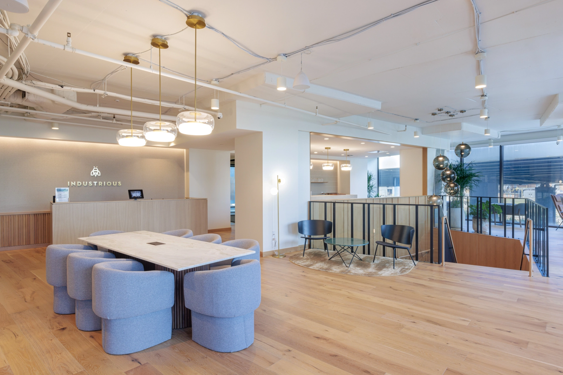 A modern coworking office in Washington DC with wooden floors and blue chairs.