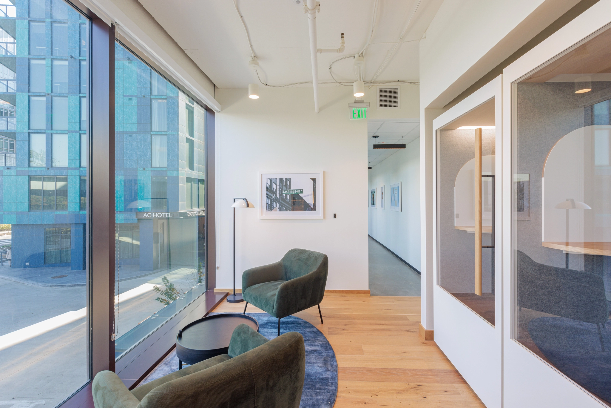 A Washington DC coworking space with glass-walled meeting rooms and chairs.