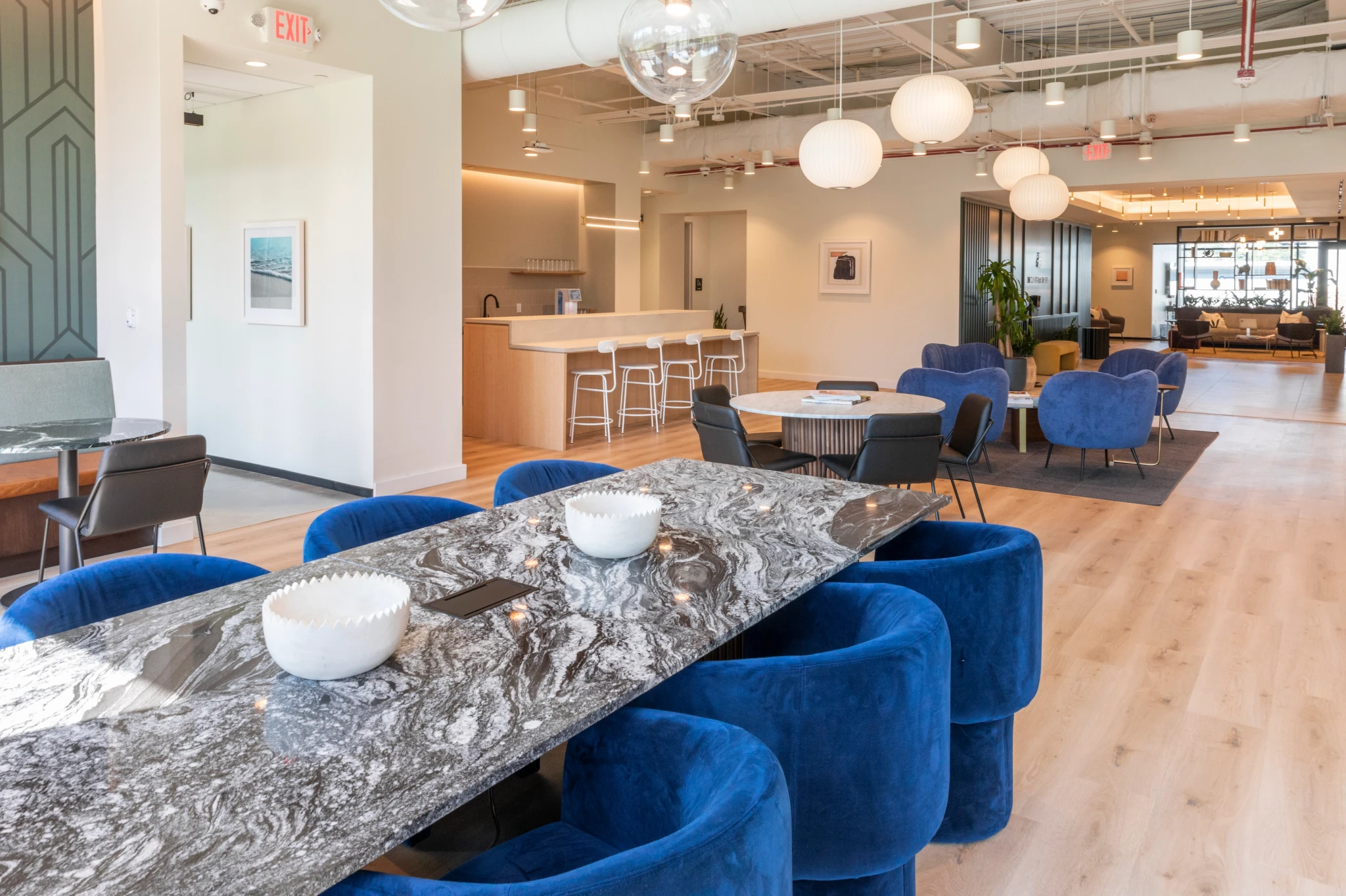 A Chapel Hill workspace with blue chairs and a marble table.