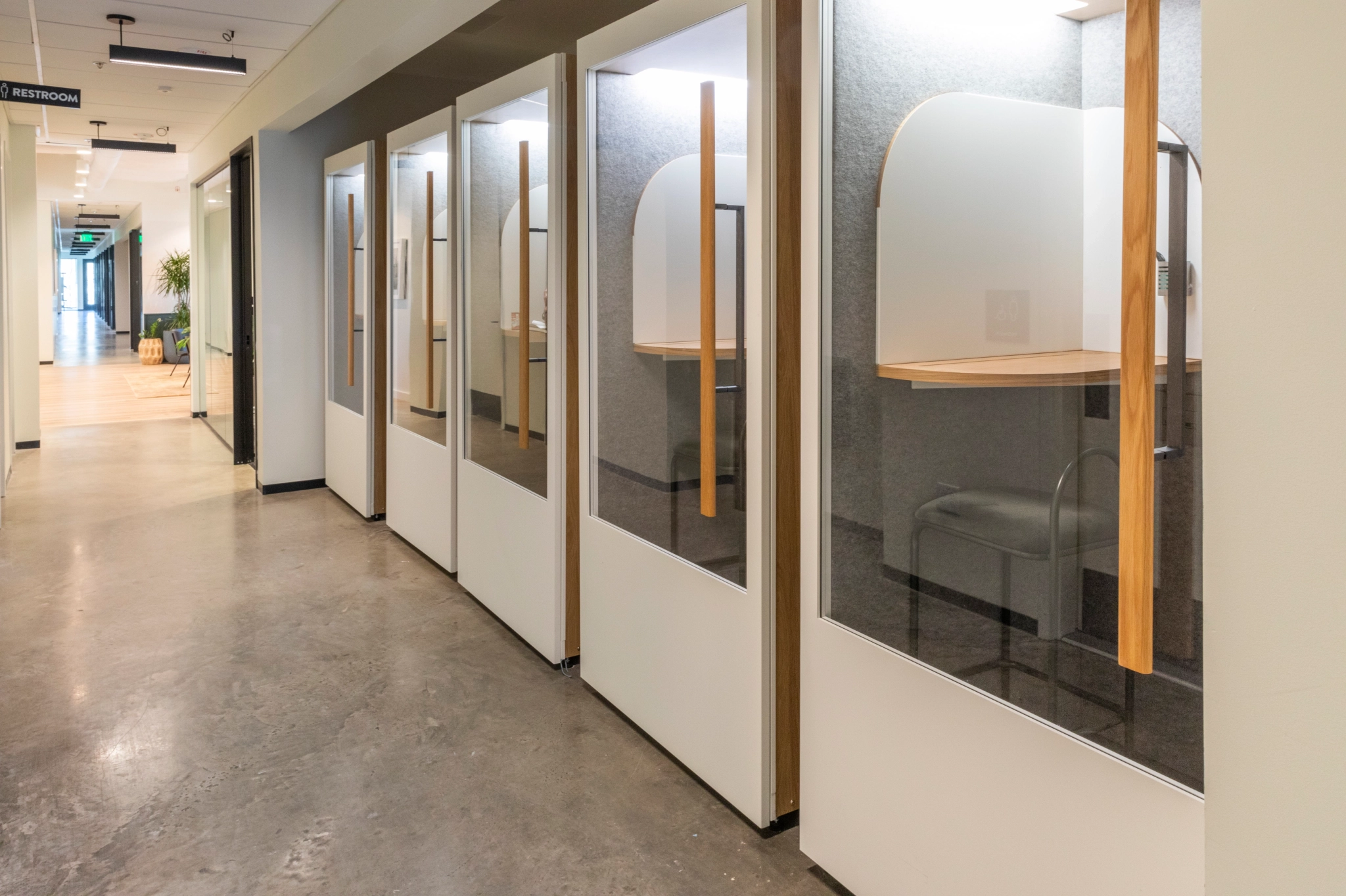 glass office cubicles in an office workspace.