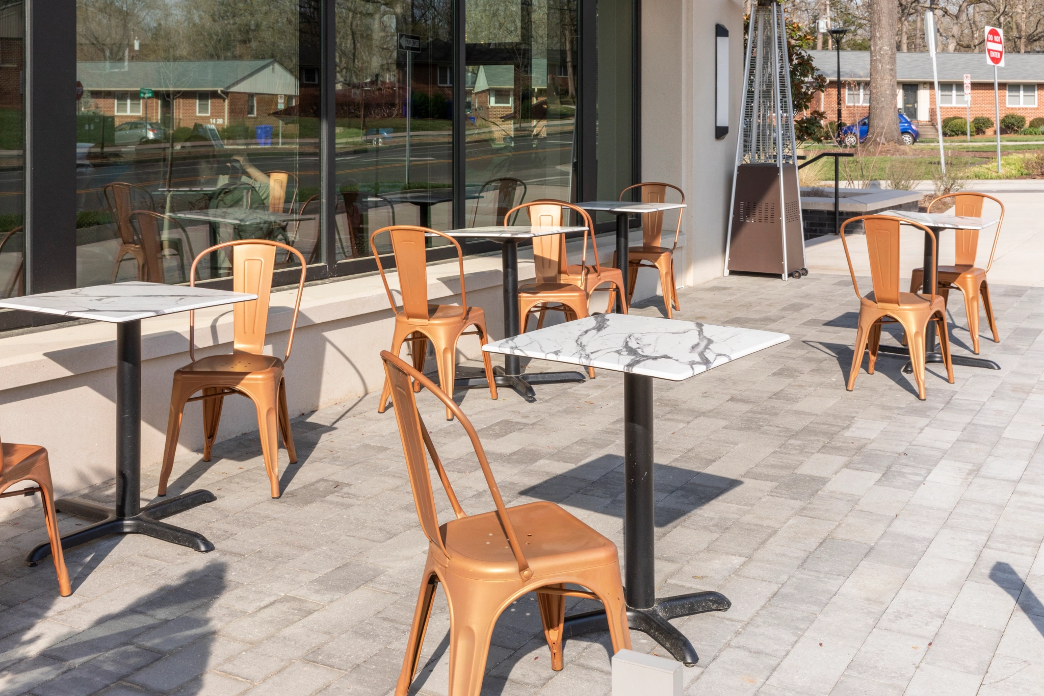 Outdoor seating area for a restaurant, with tables and chairs.