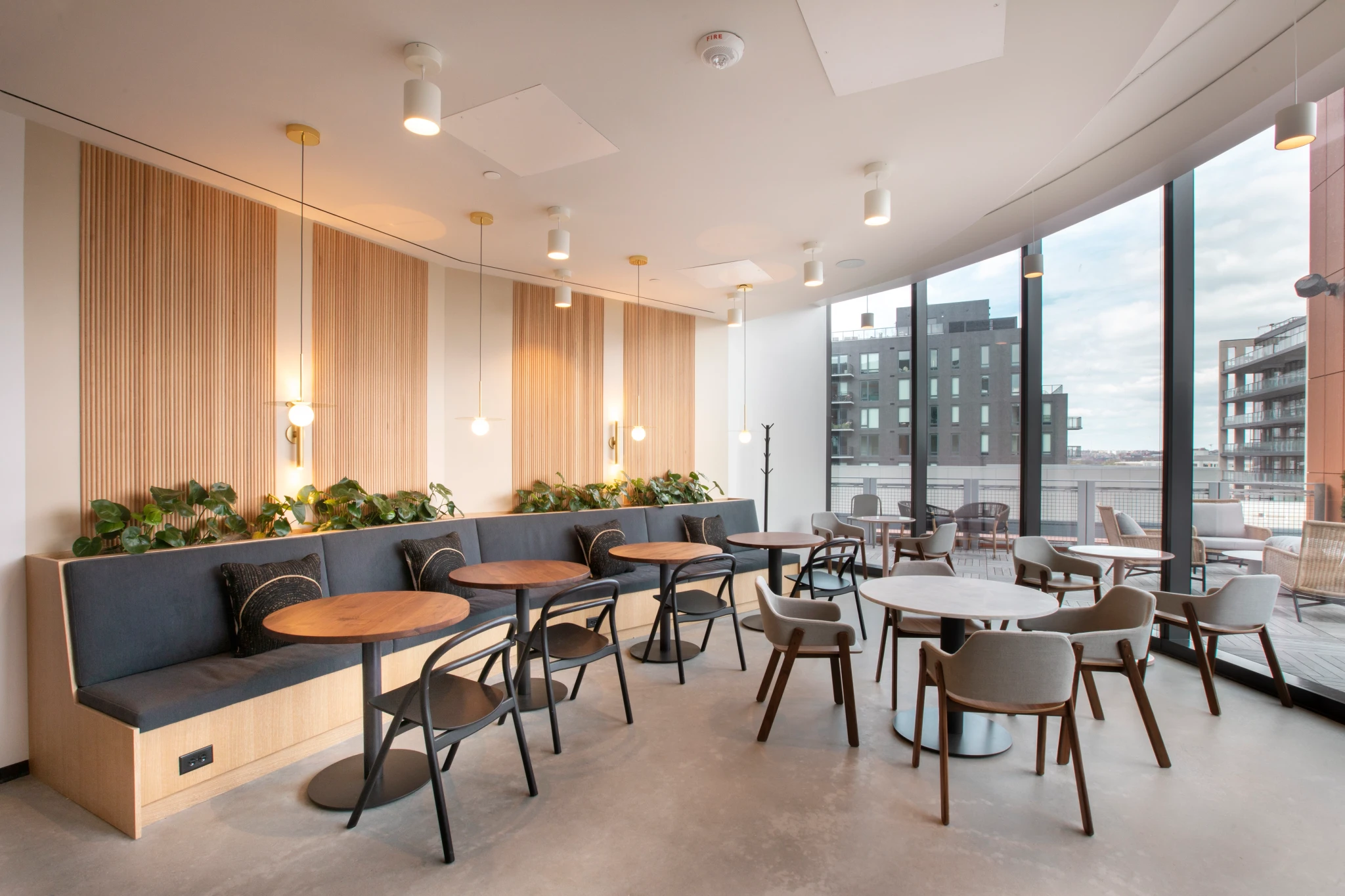a coffee shop with tables and chairs providing a workspace for professionals.