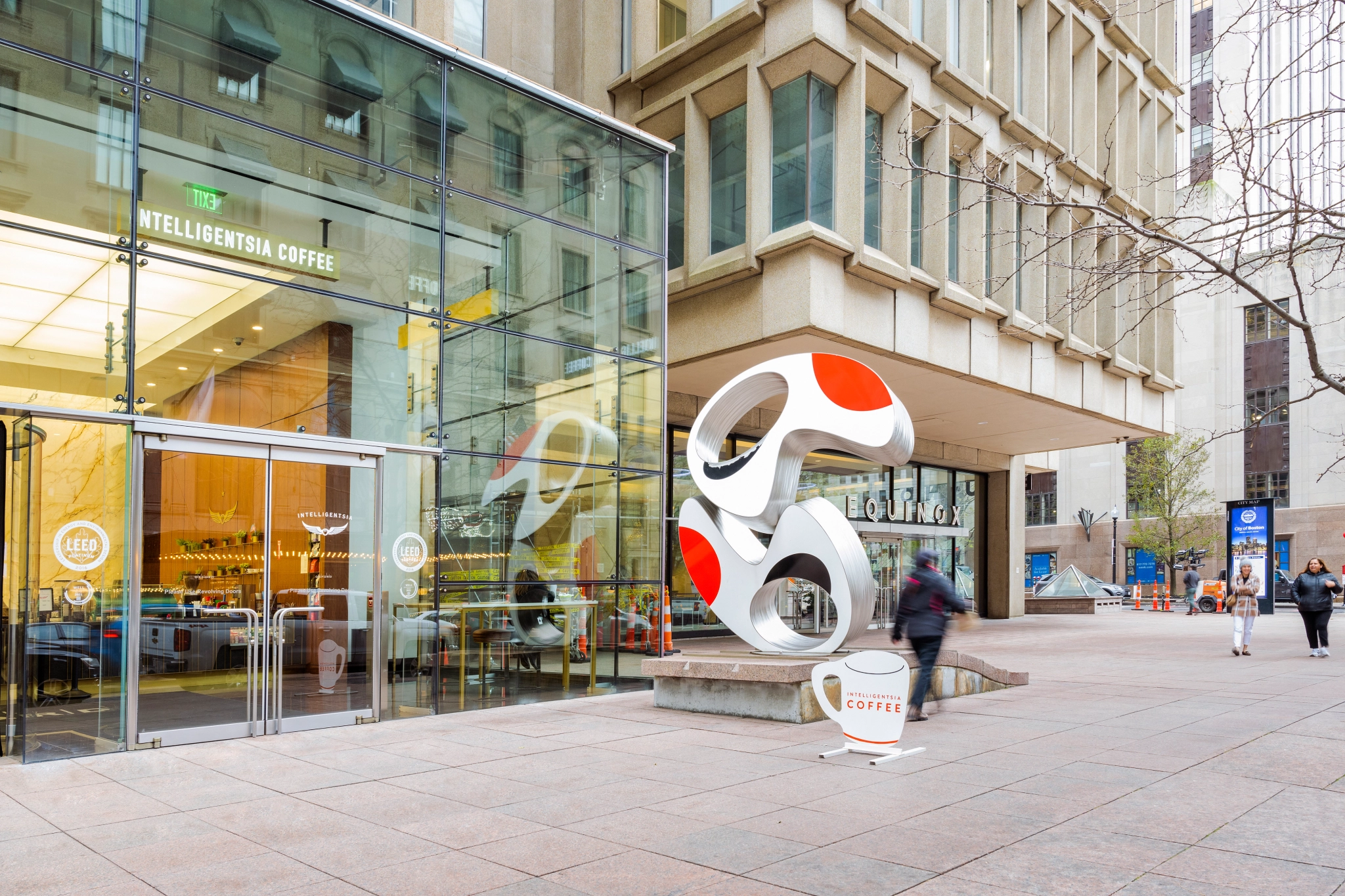 A large glass building with coworking spaces and meeting rooms in Boston.