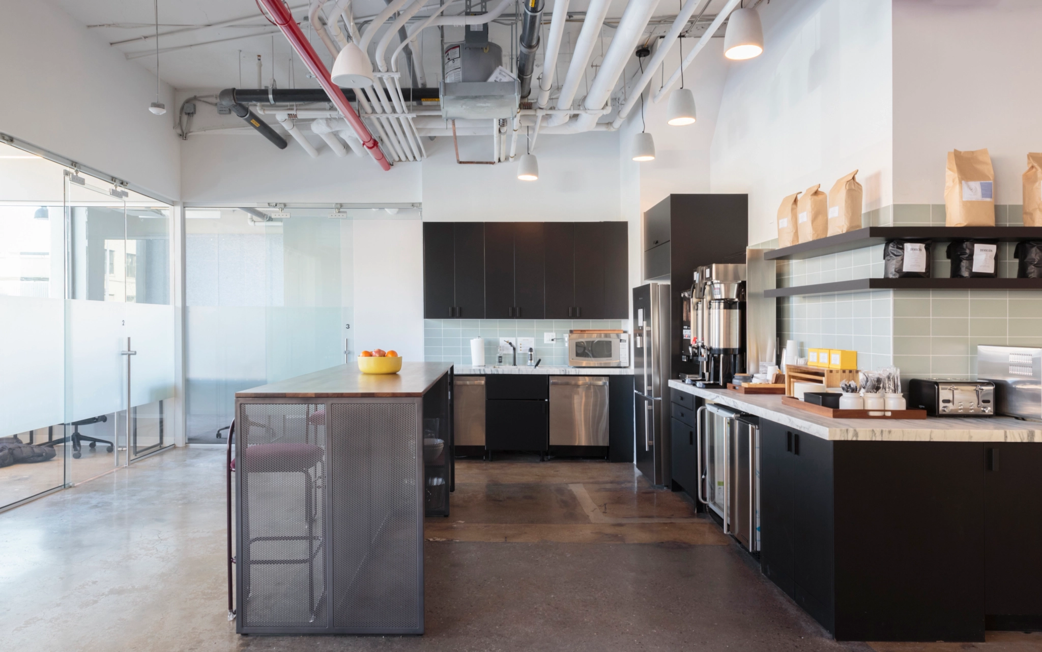 a kitchen with black cabinets and counter tops.