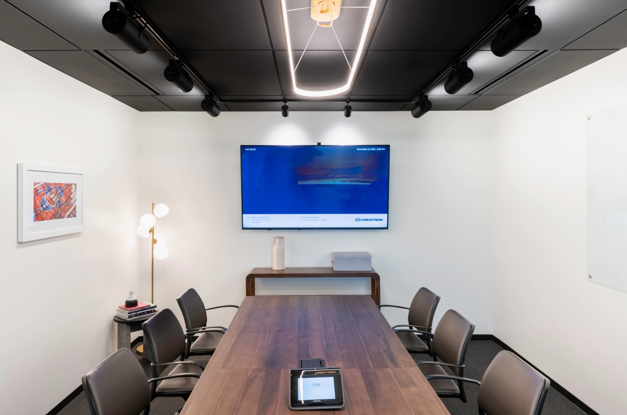 A coworking meeting room in Pasadena with a wooden table and a TV.