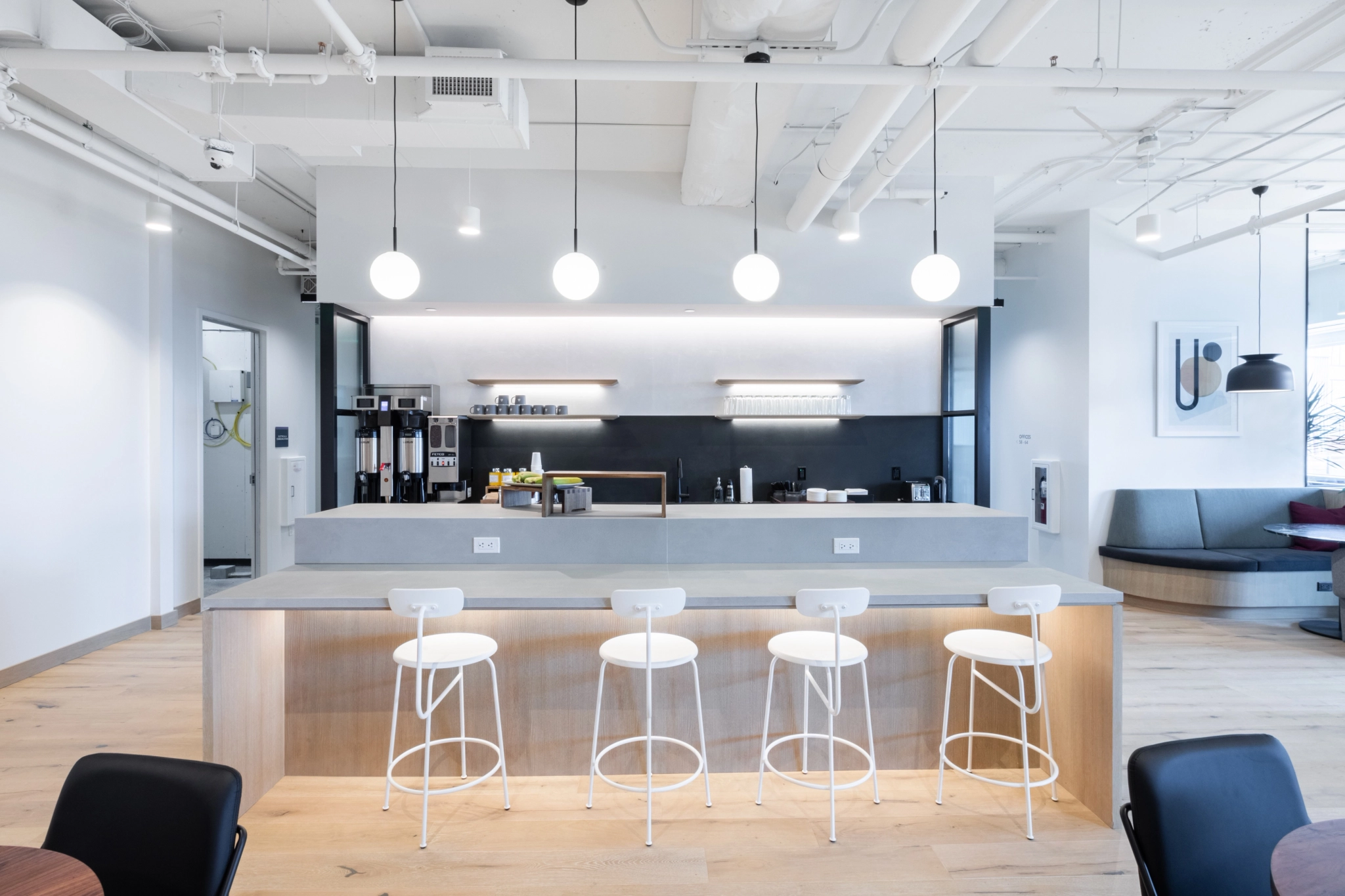 A North Bethesda workspace with a modern office and meeting room furnished with bar and stools.