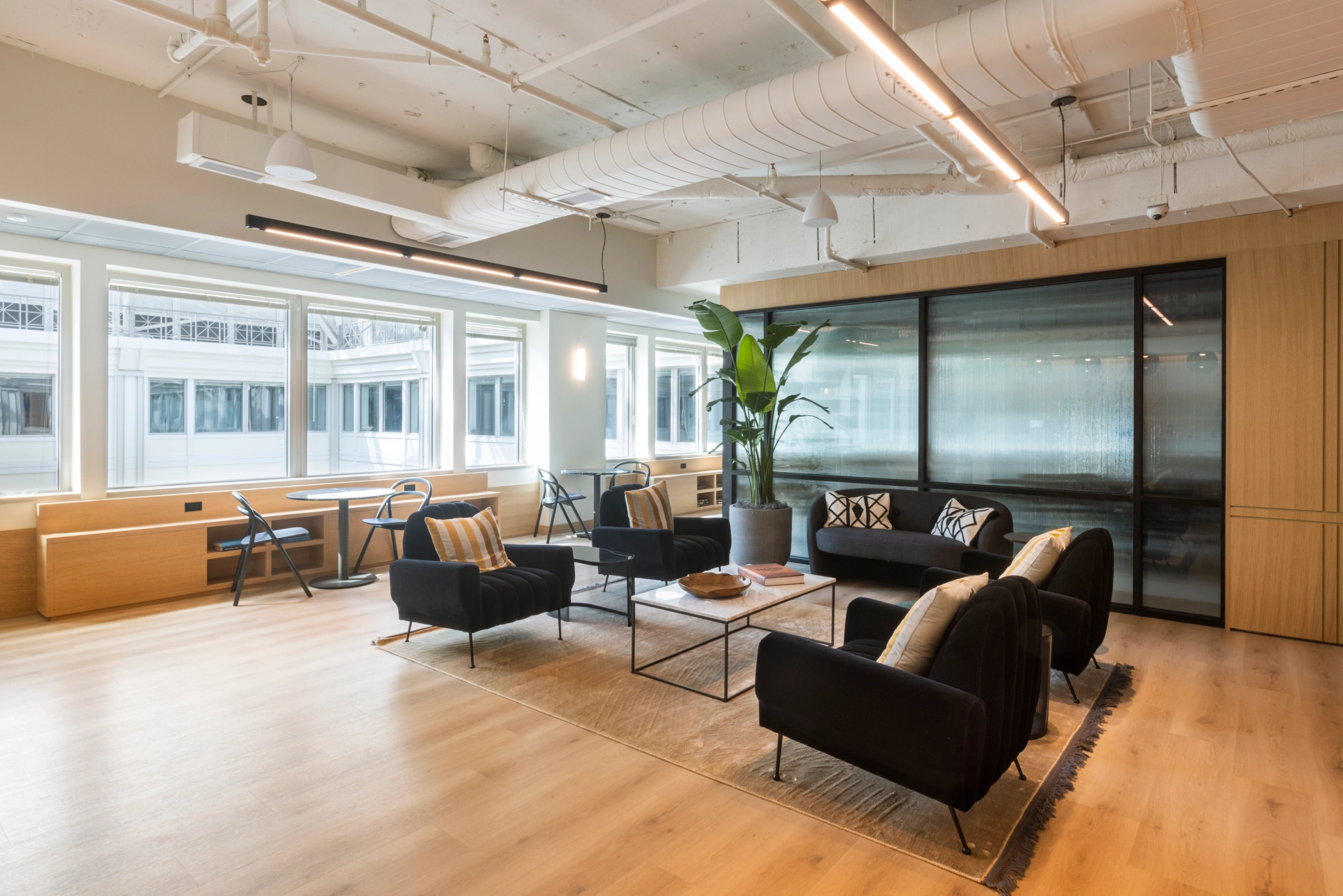 a modern Washington office with wooden floors and large windows, featuring a spacious meeting room.