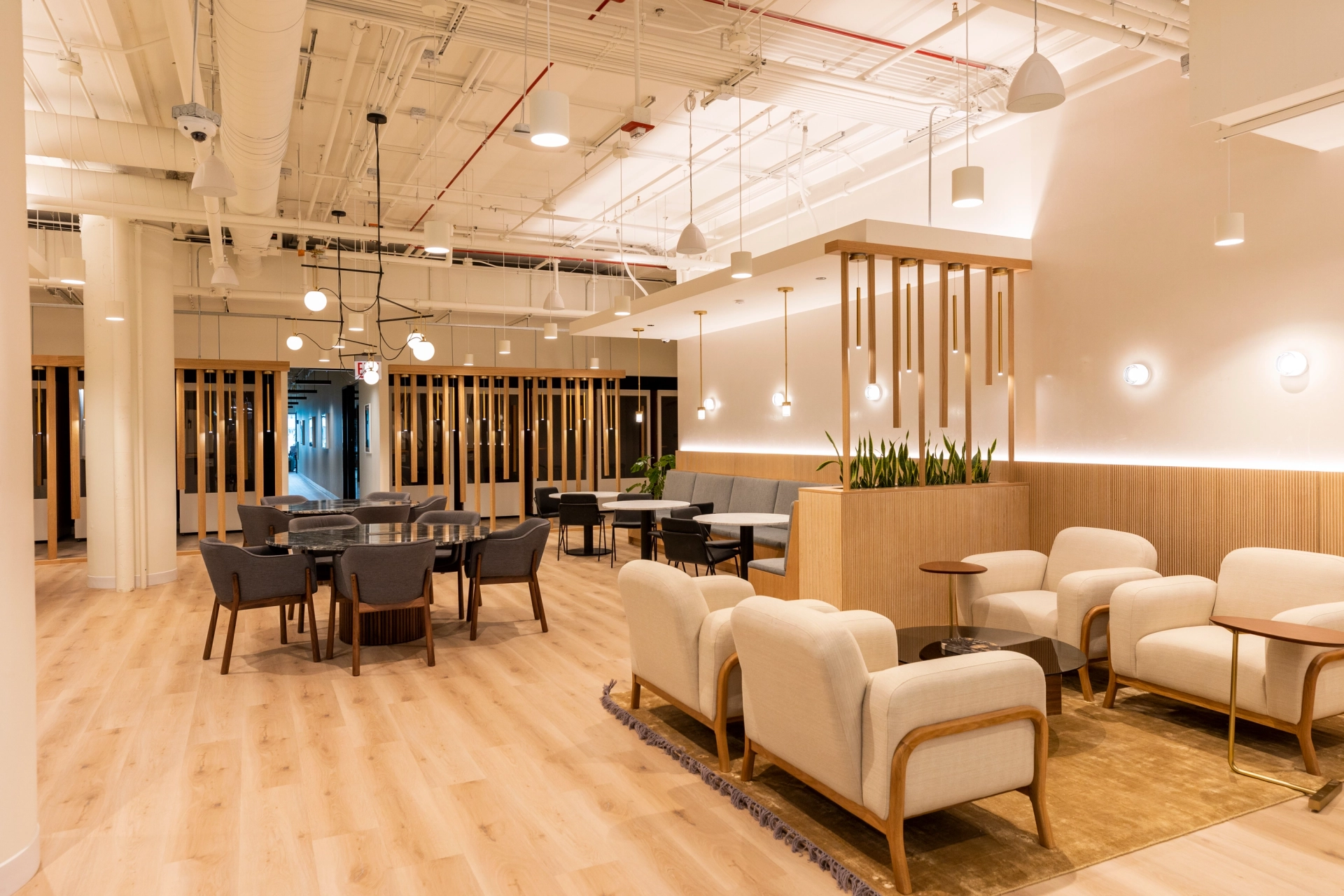 a modern coworking office with white furniture and wooden floors.
