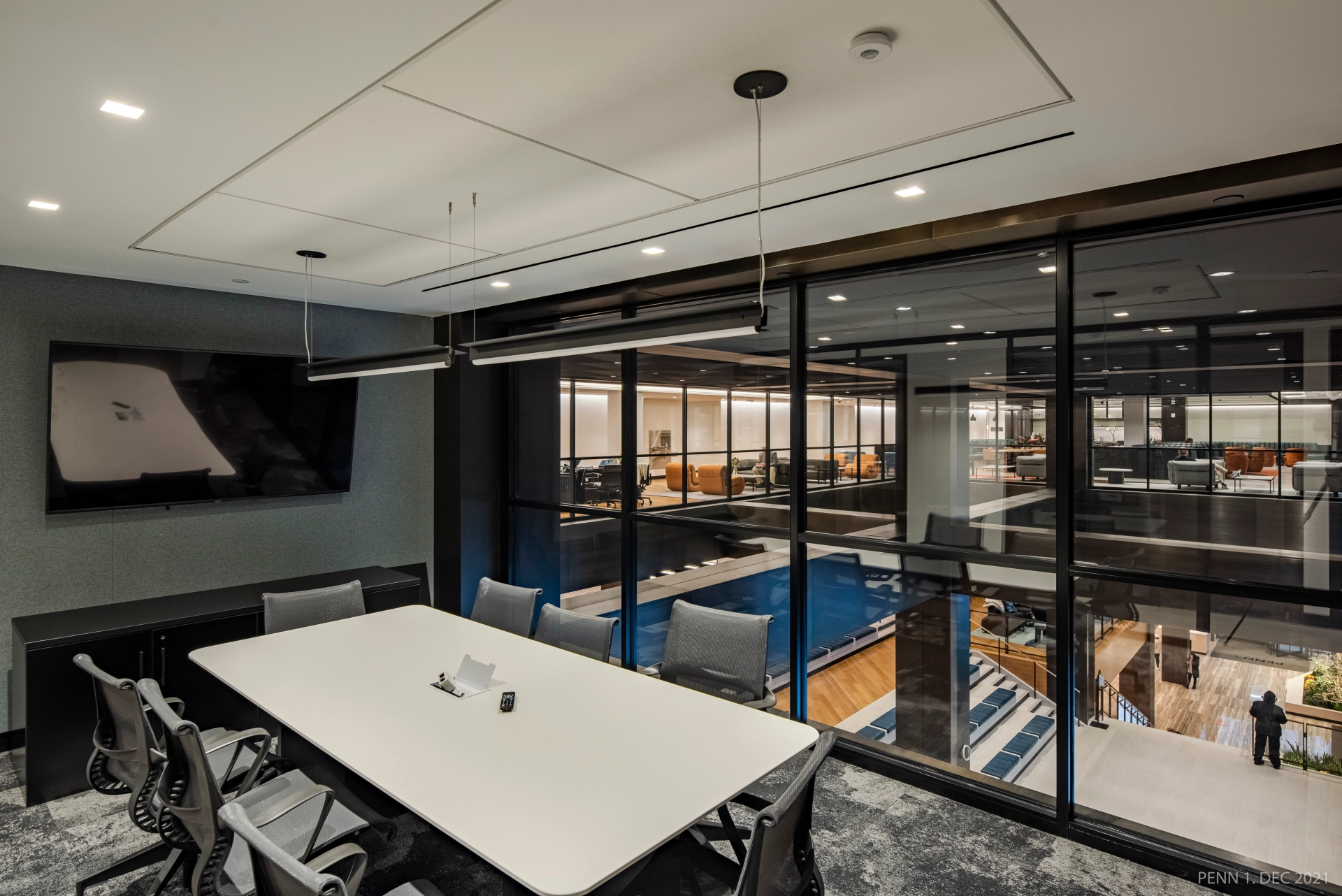 An office conference room in New York with glass walls and a table for coworking purposes.