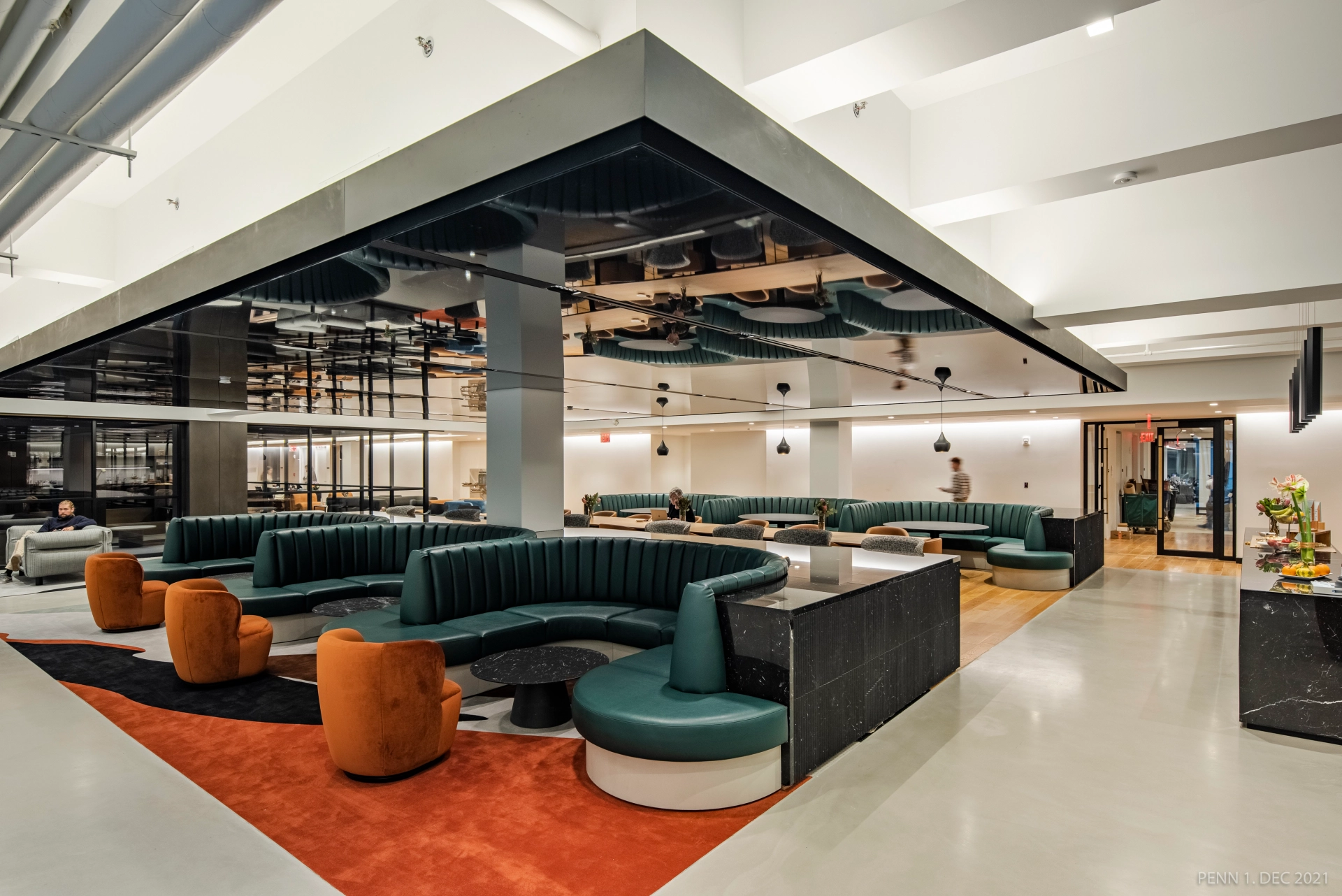 A modern workspace in New York with orange and green seating.