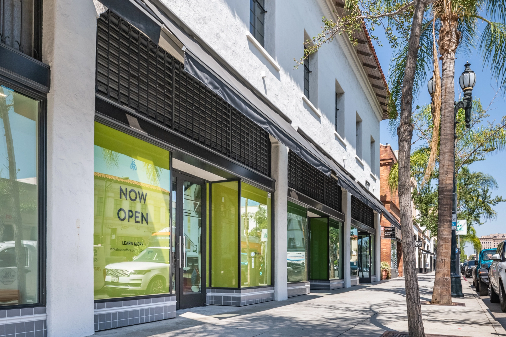 A Pasadena street scene with a storefront surrounded by palm trees.