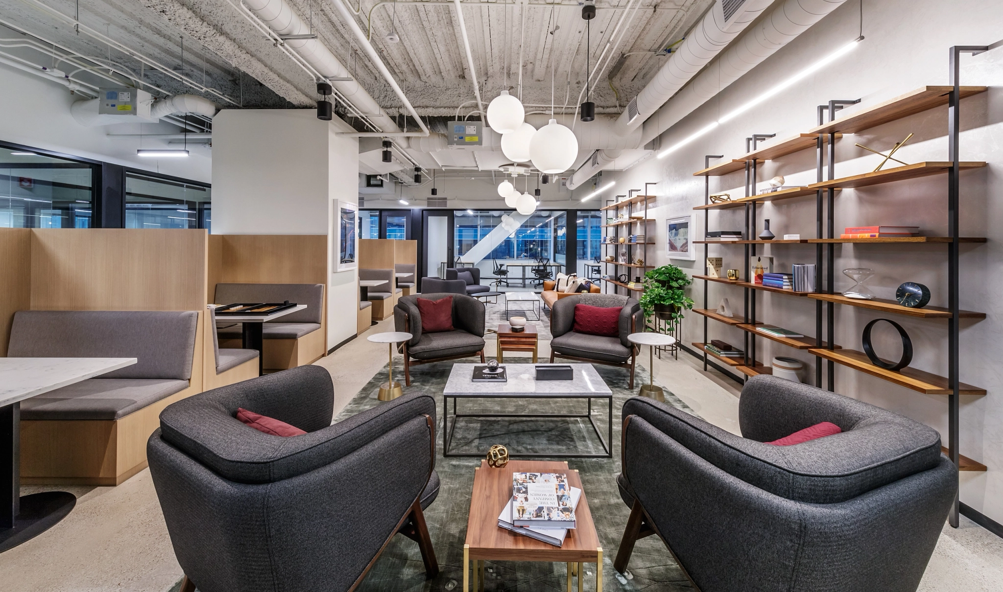 A modern coworking office in Chicago with couches, tables, and bookshelves.