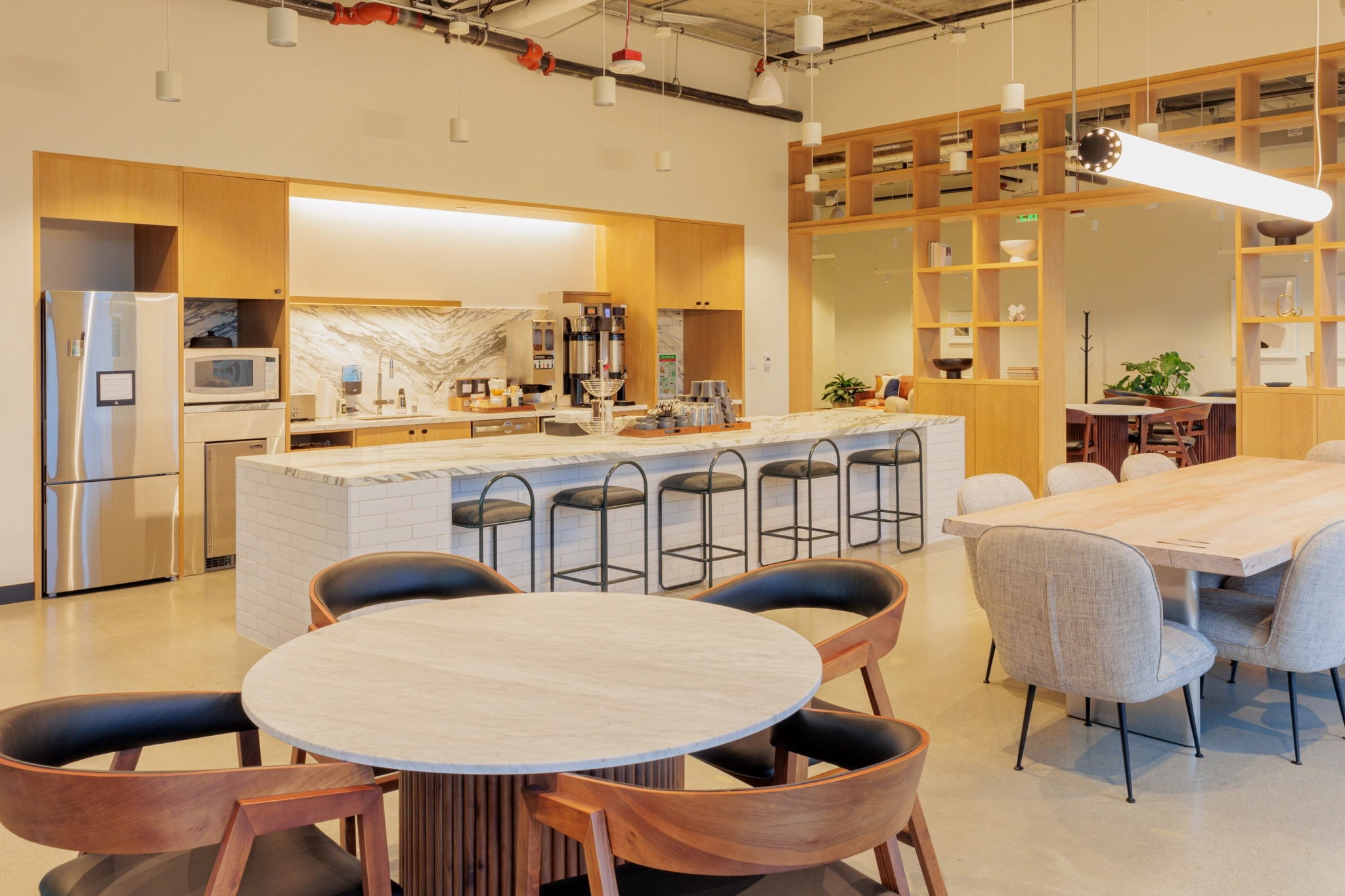 A kitchen and dining area in an office workspace.