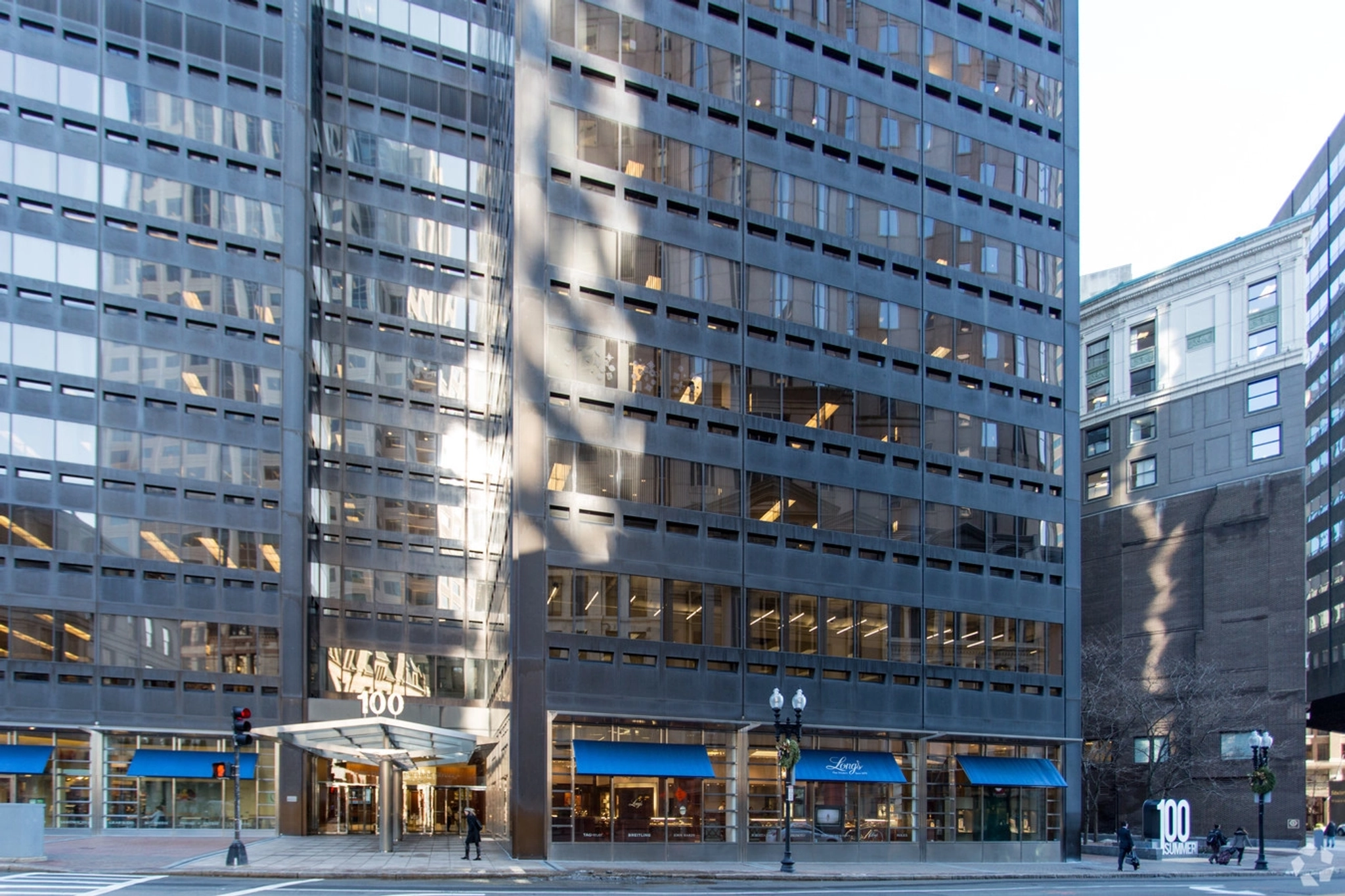 A spacious coworking space with blue awnings in the heart of a bustling city.