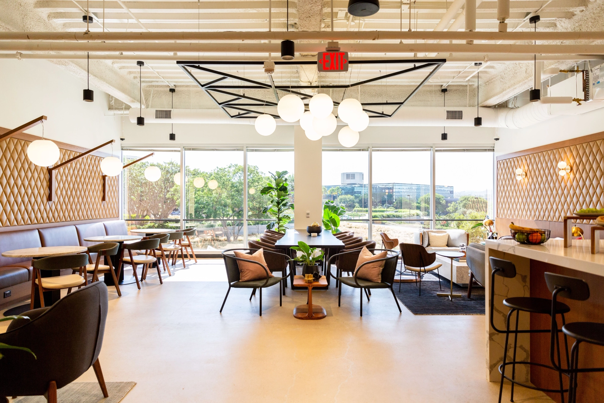 A restaurant in Irvine with tables, chairs, and a meeting room available for coworking.