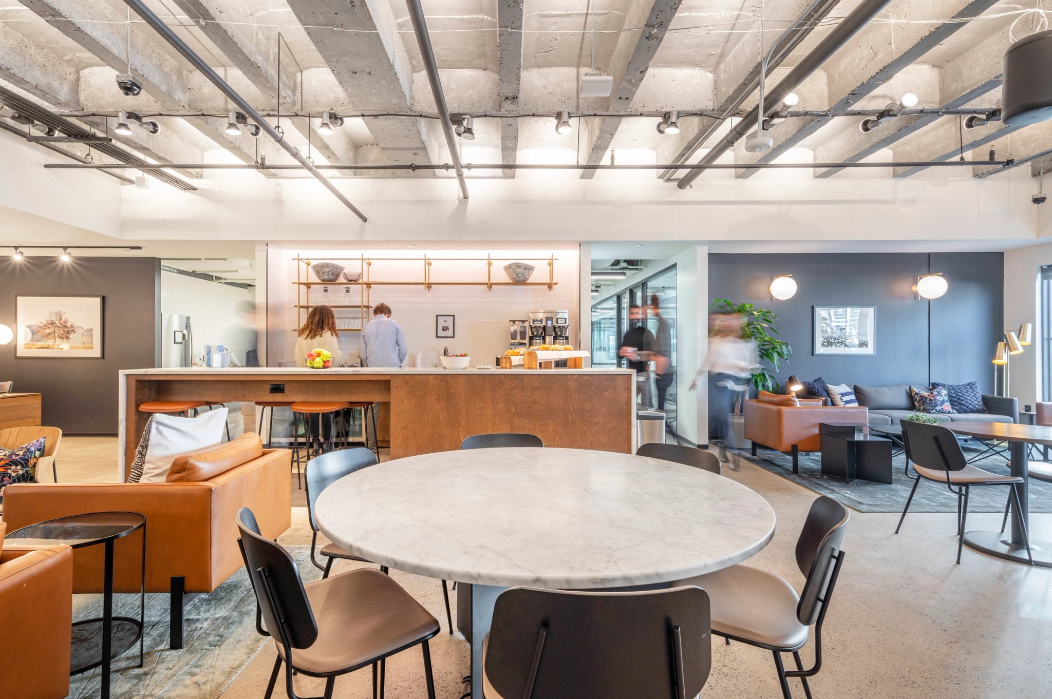 a contemporary meeting room with a table and chairs.