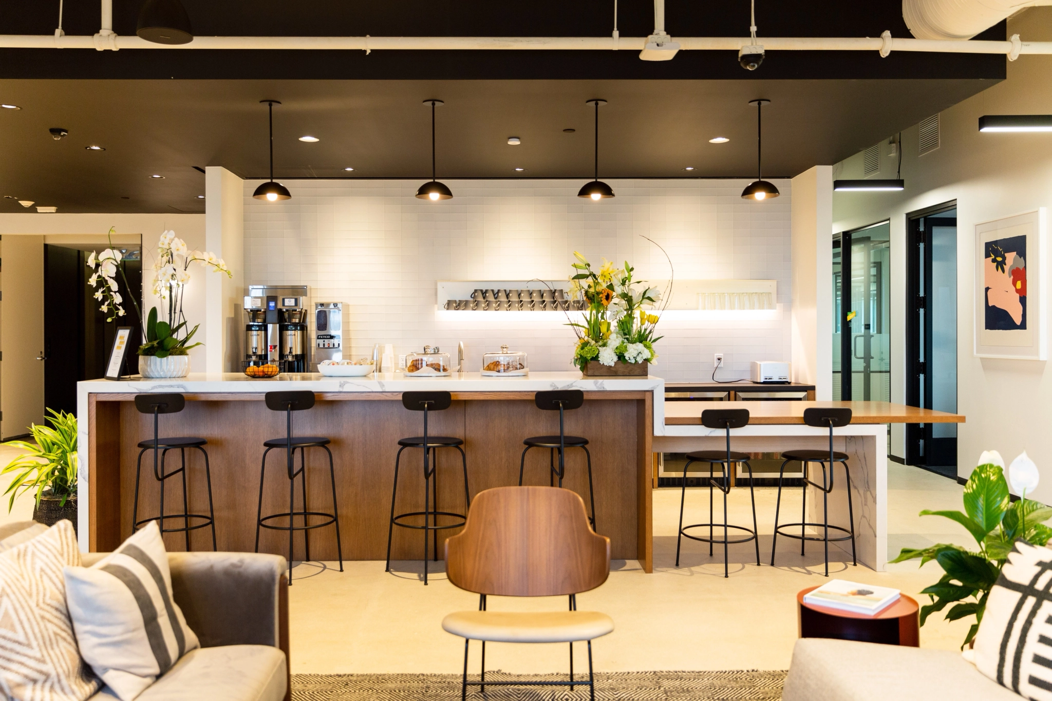 A contemporary workspace with a bar and chairs.