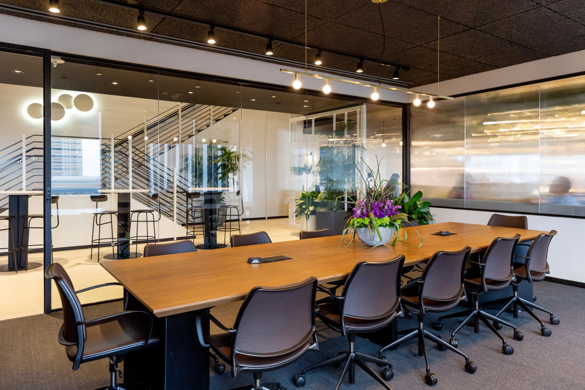 A spacious conference room with a large table and chairs for office meetings.