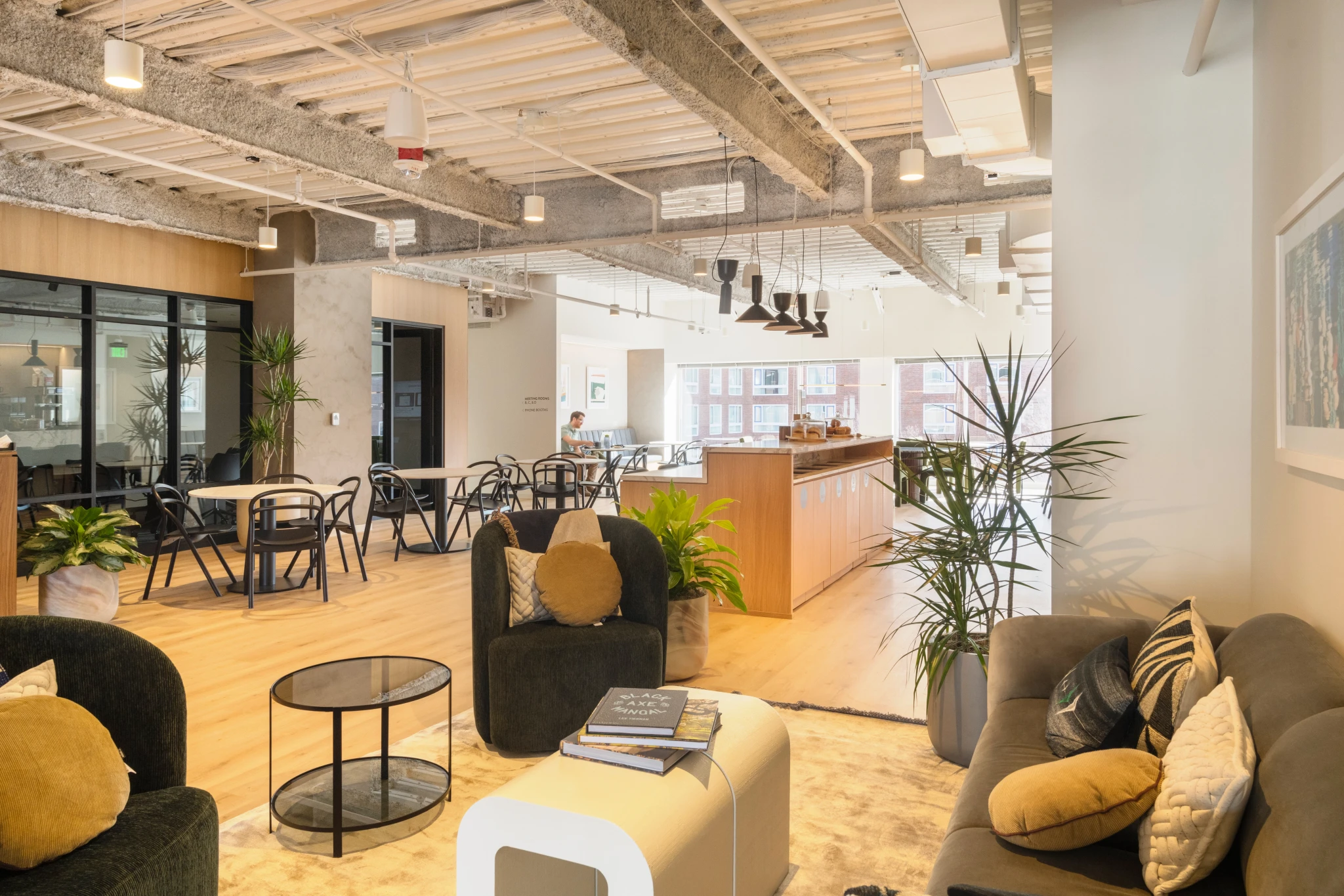 a modern coworking space in Cambridge with a wooden floor and a coffee table.
