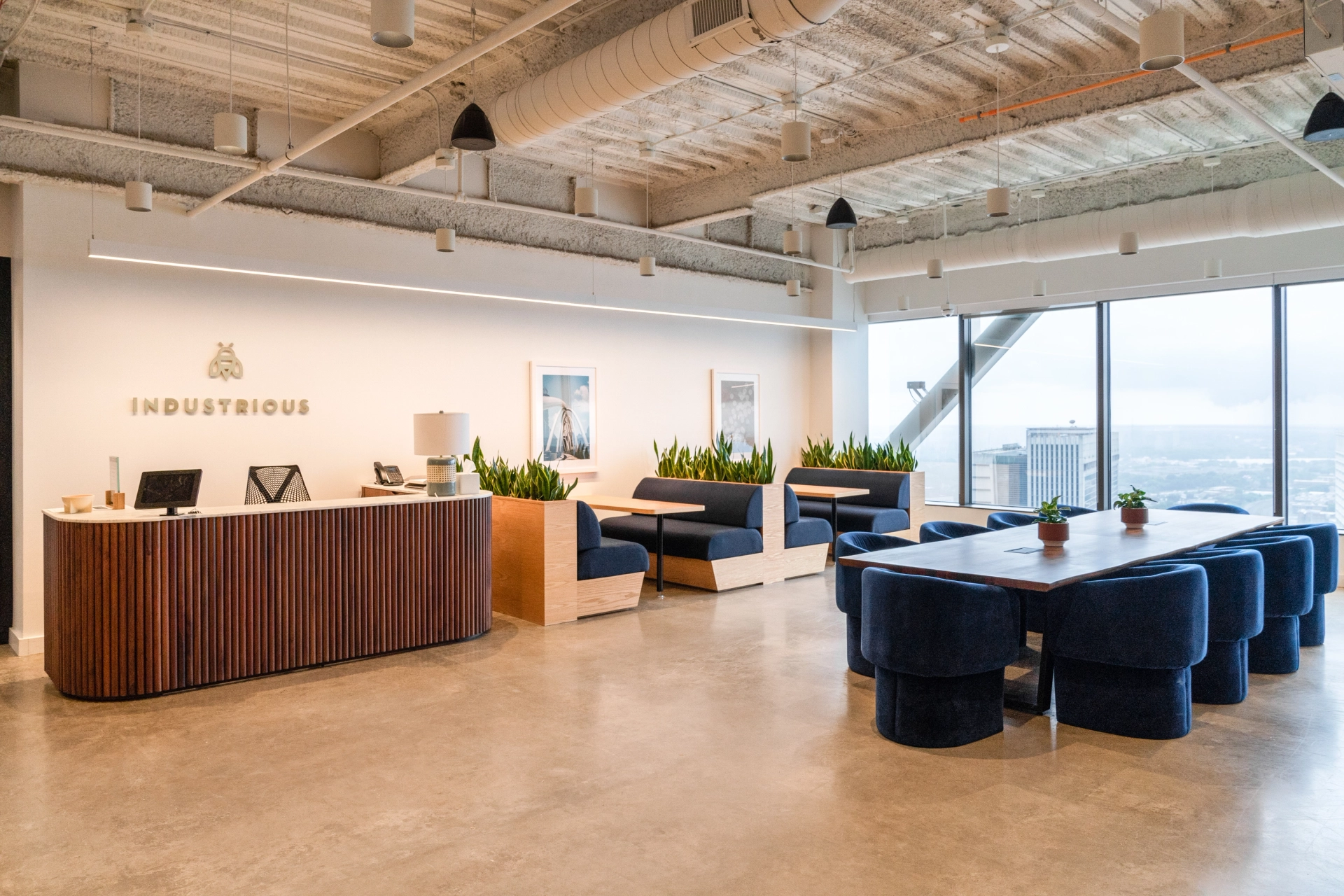 A coworking space in Atlanta with a large window overlooking the city.