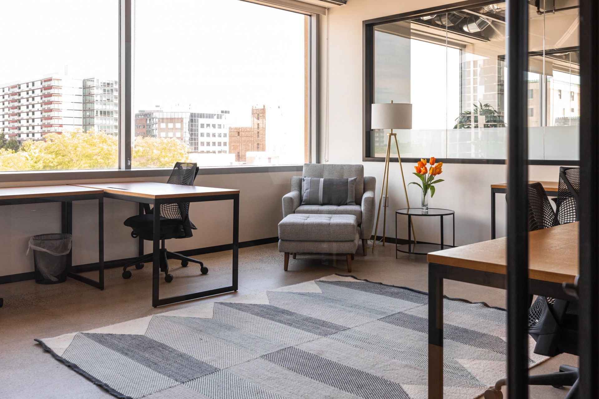 A coworking office with two desks and a window.