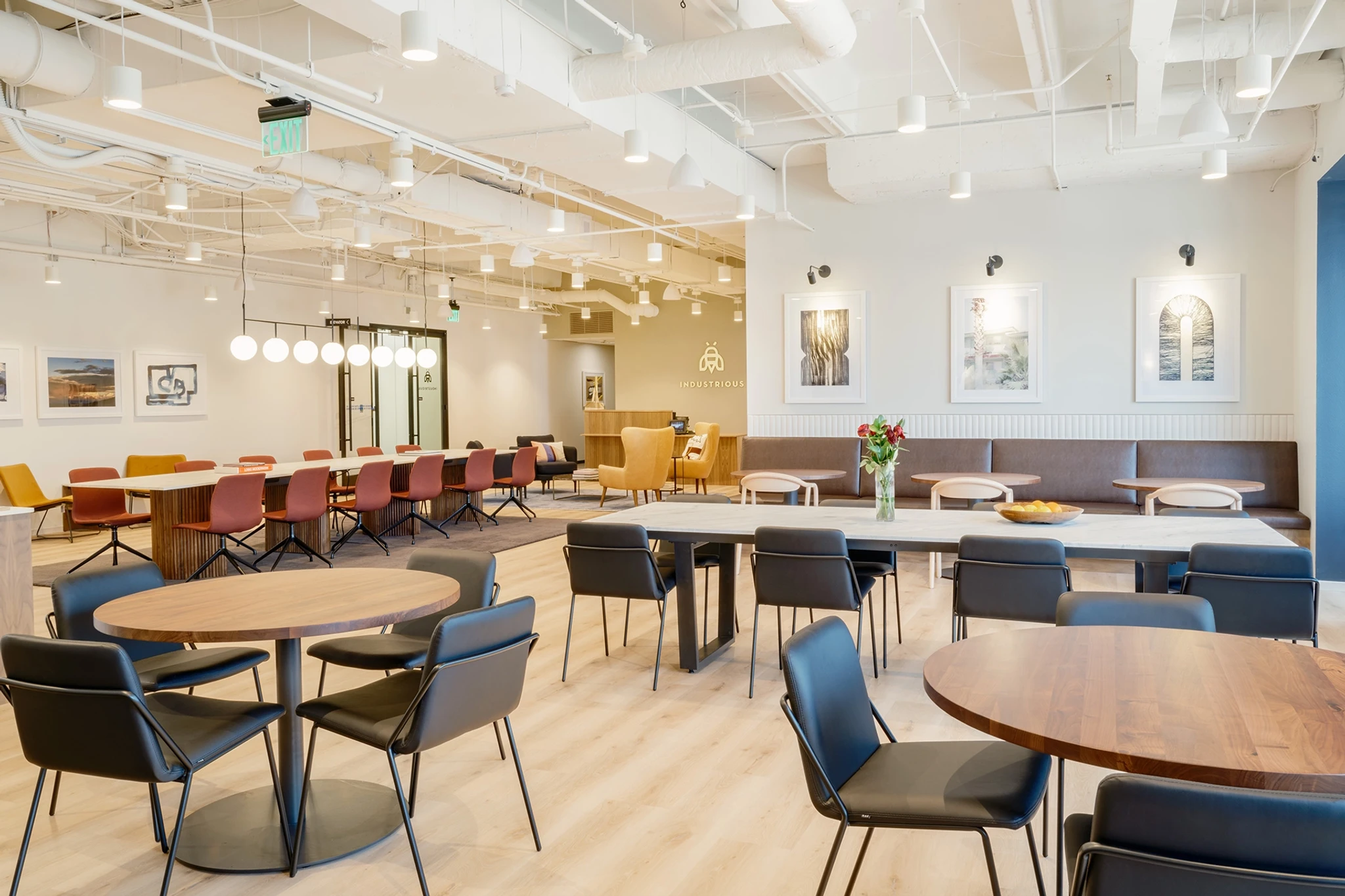 Modern coworking office break room in Austin with a variety of seating options and decorative lighting.