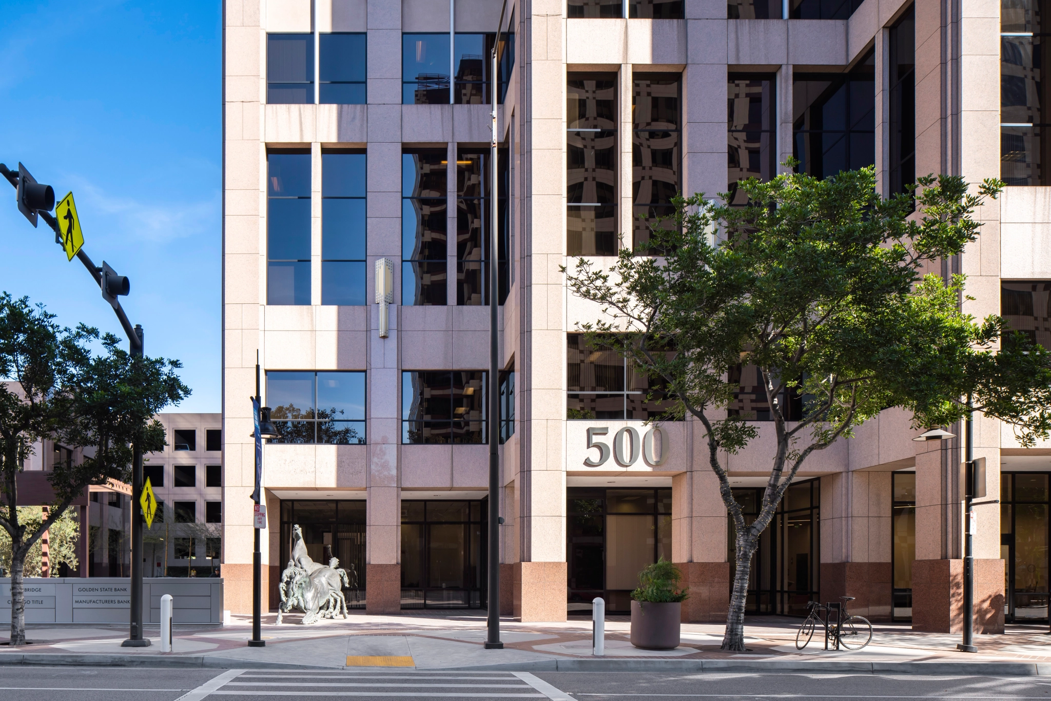 A tall building with an office and a street sign.