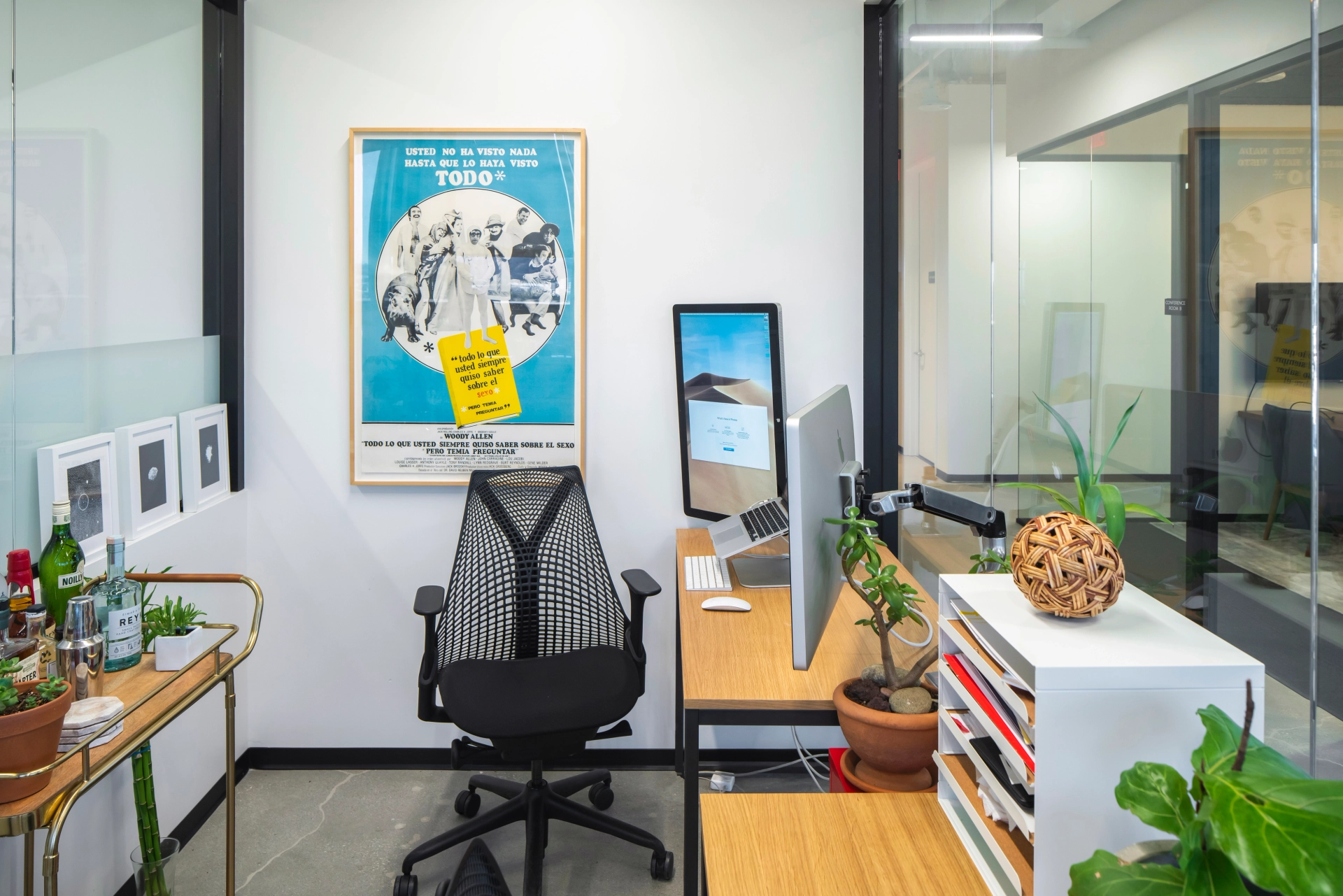 A coworking space in Glendale with a desk, chair, and a poster.