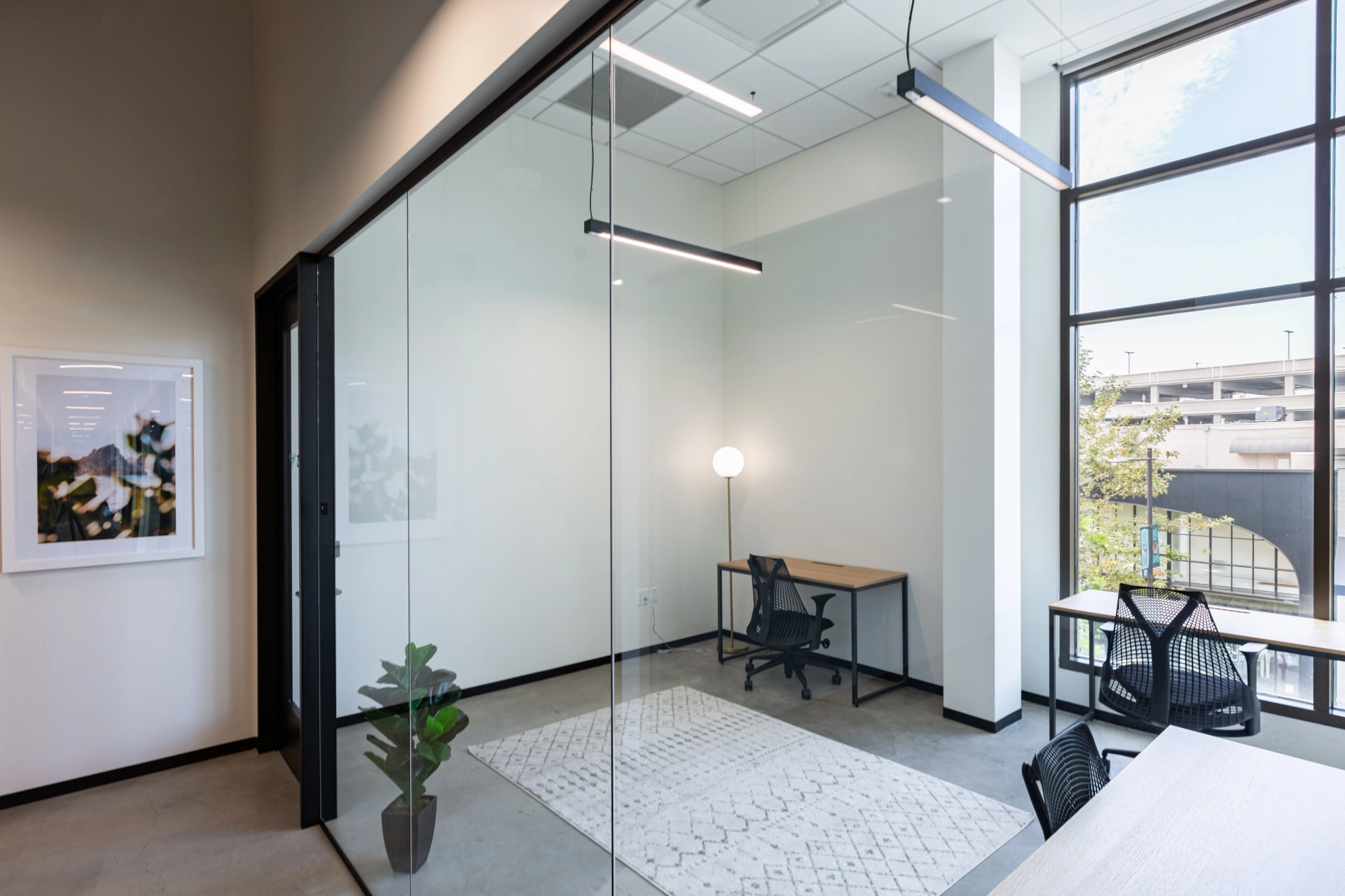 A Walnut Creek coworking space with glass-walled meeting rooms and desks.