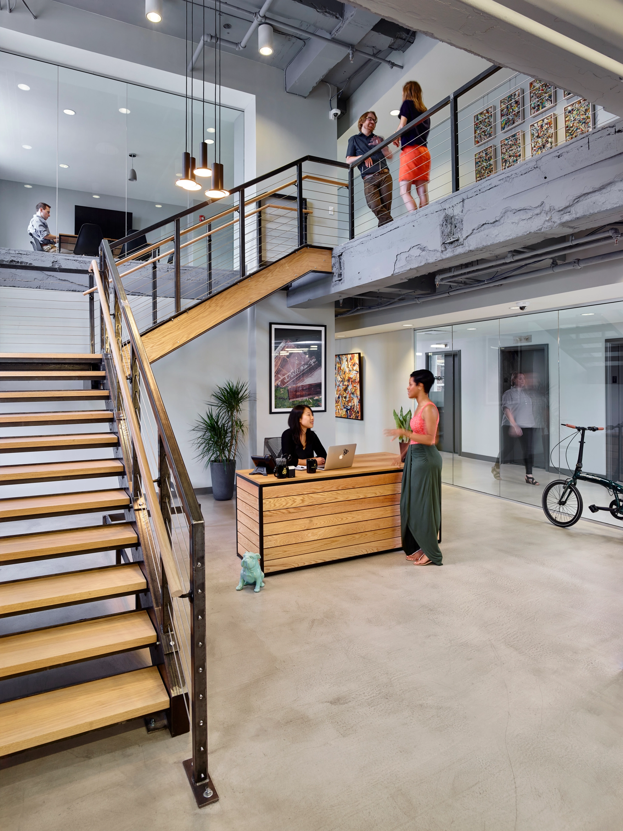 a modern office with a reception area and stairs.