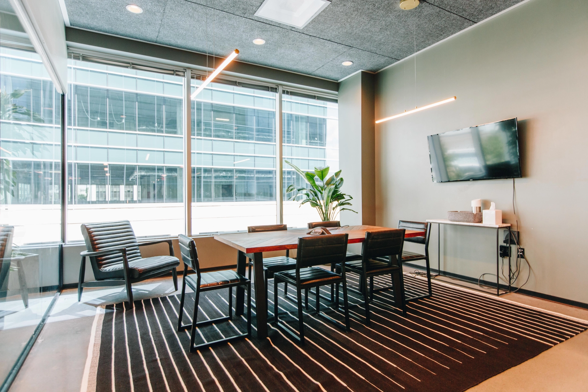 a coworking space with a conference table and chairs.