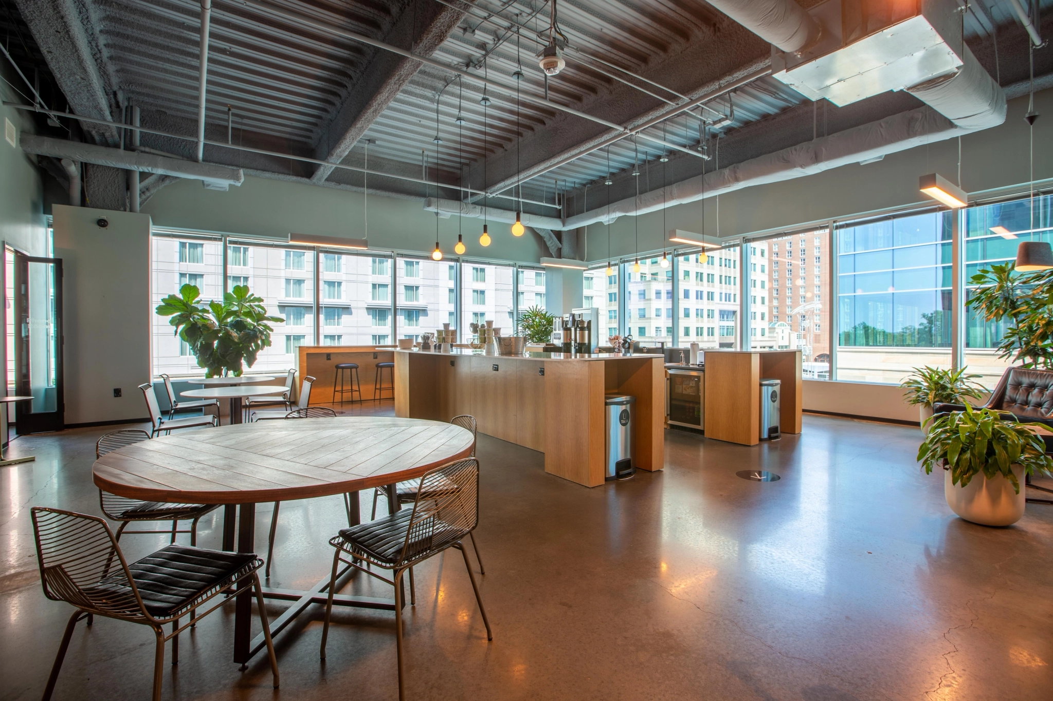 a large coworking space with tables and chairs.