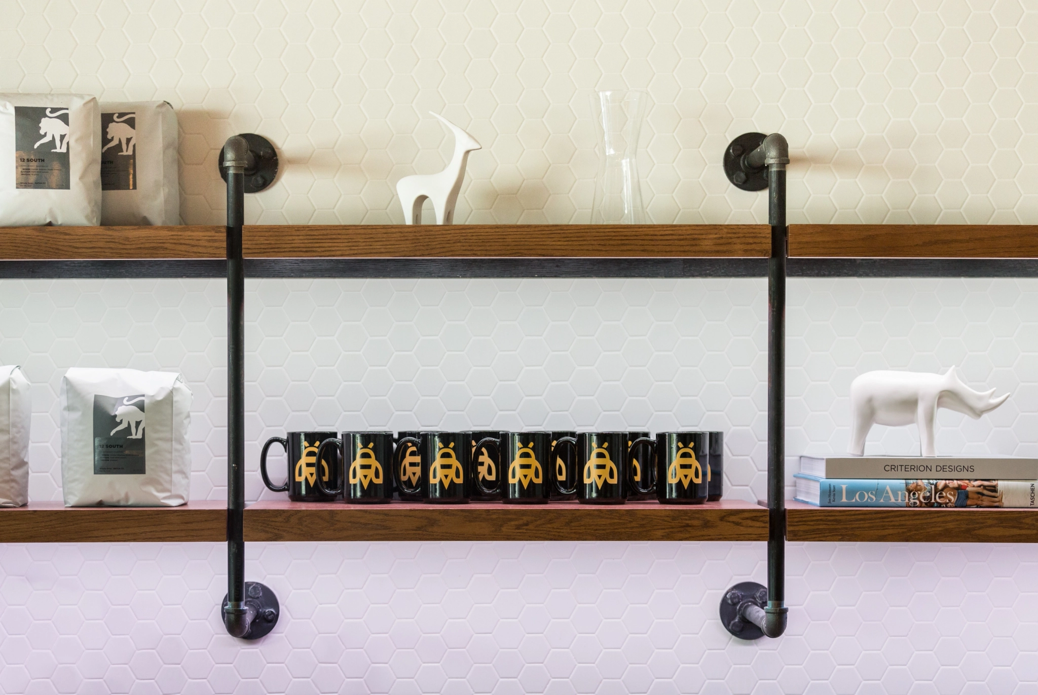 A coffee mugs shelf in a coworking office meeting room.