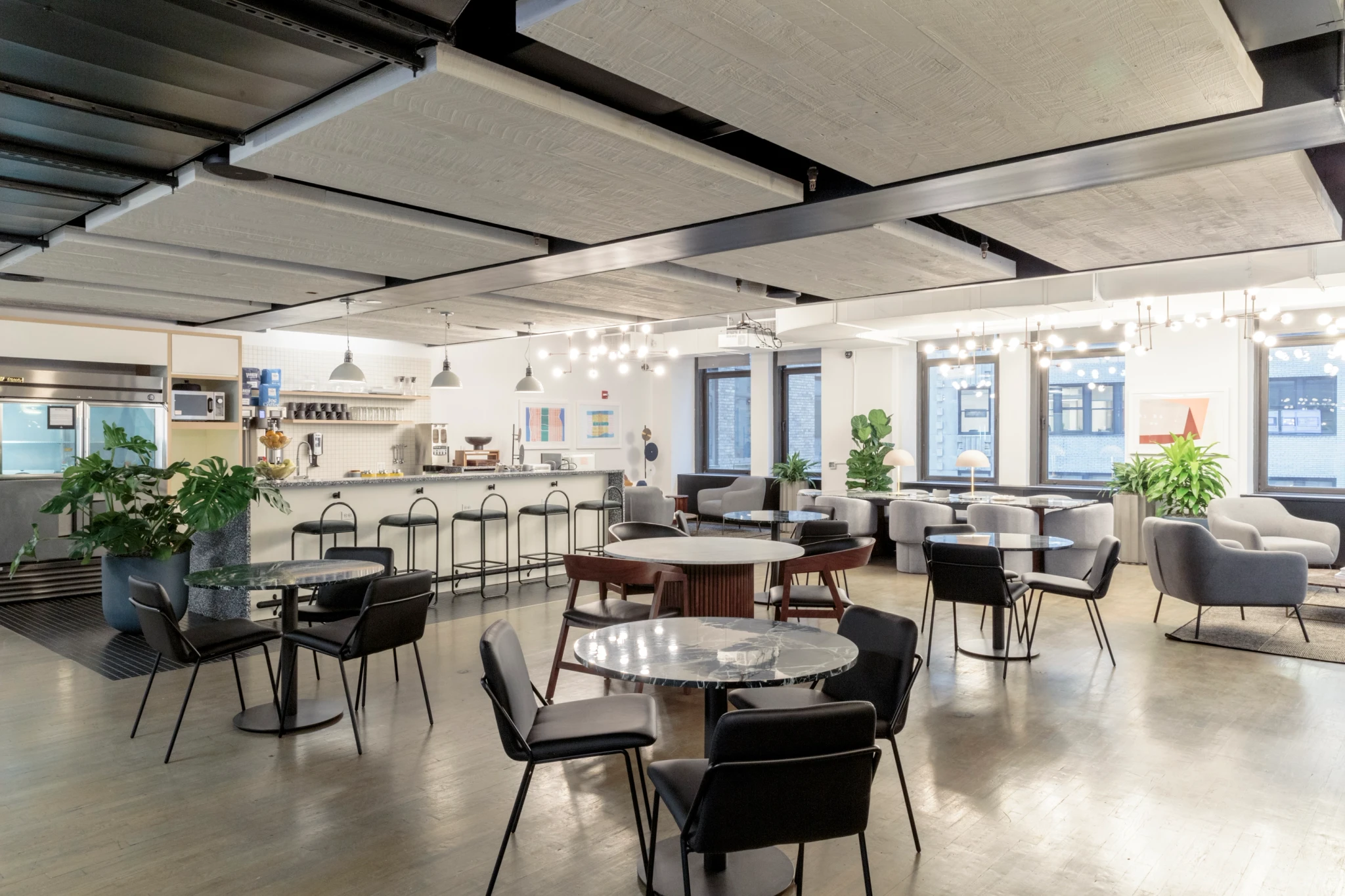 A modern workspace with tables and chairs.