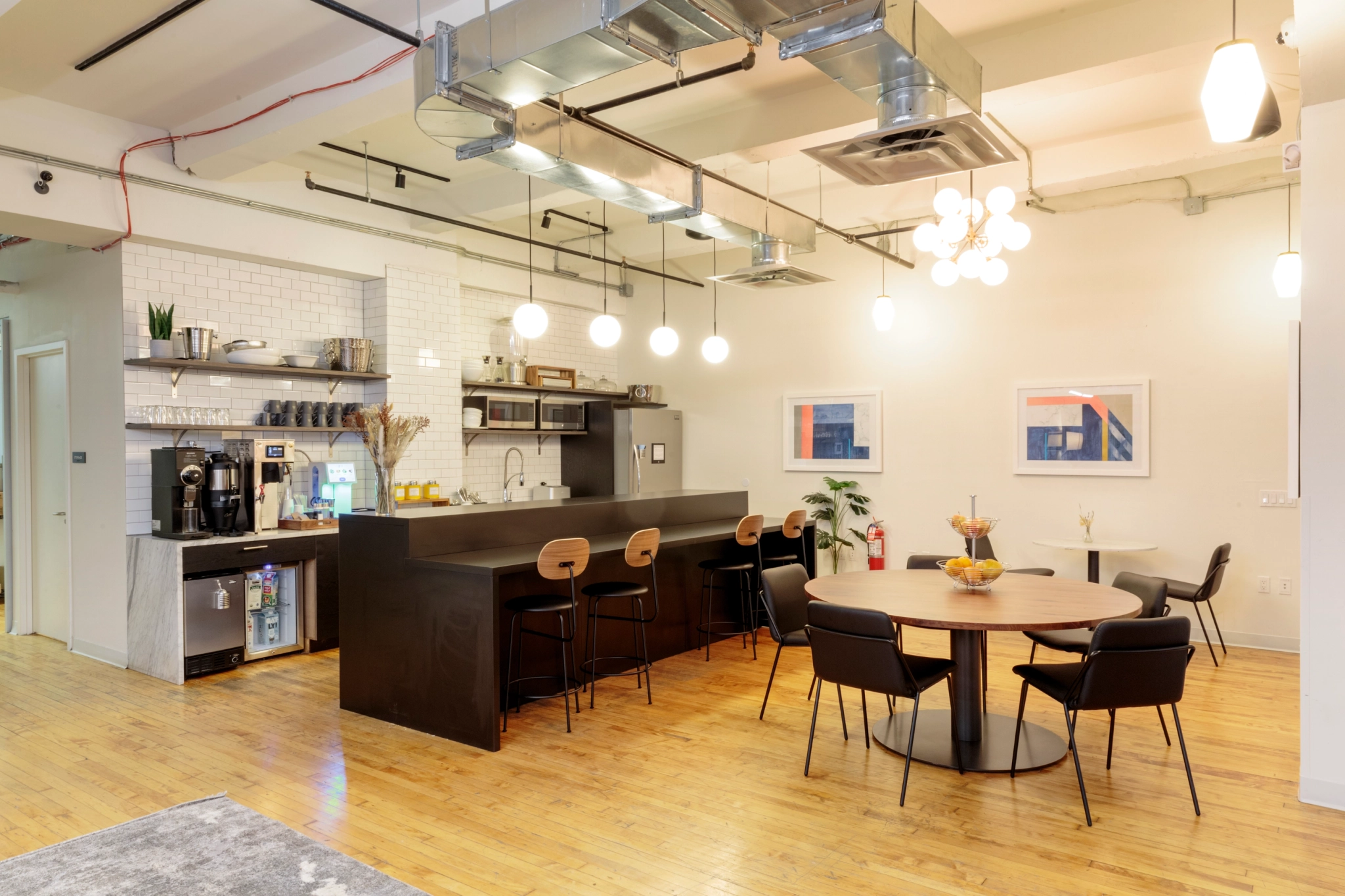 A modern office in New York with a kitchen and dining area.