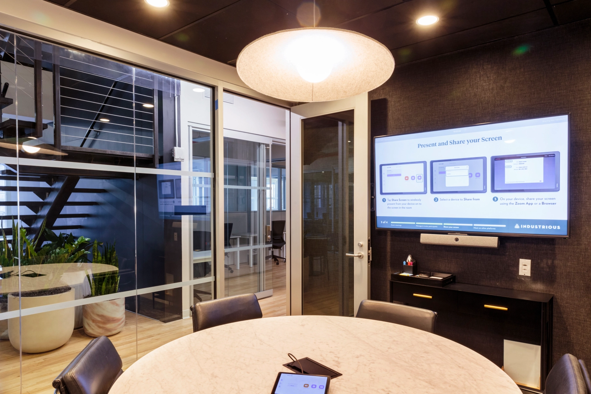 A New York meeting room designed as a workspace with a TV on the wall.