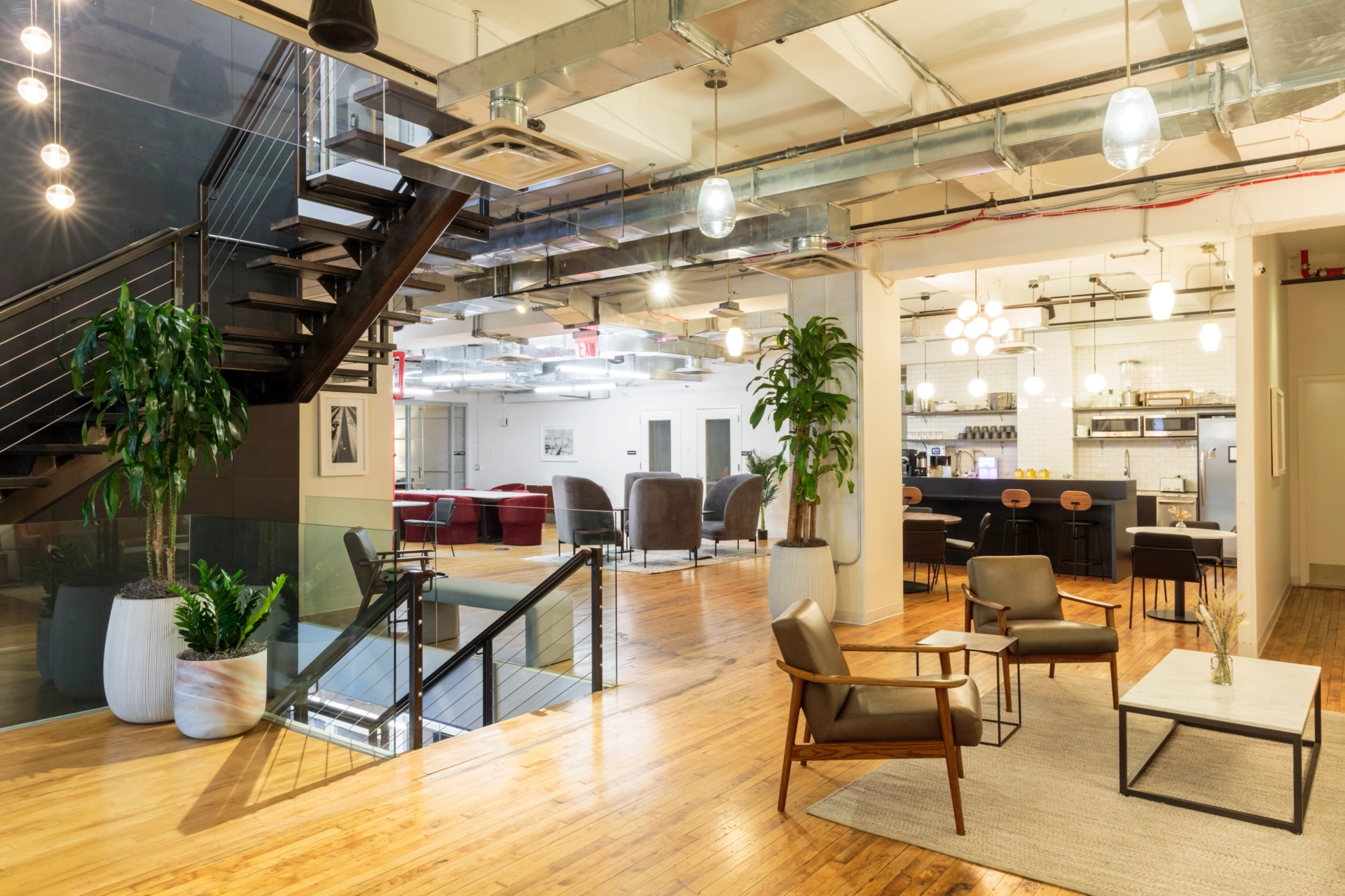 A coworking office in New York with a modern design, featuring a staircase and wooden floors.