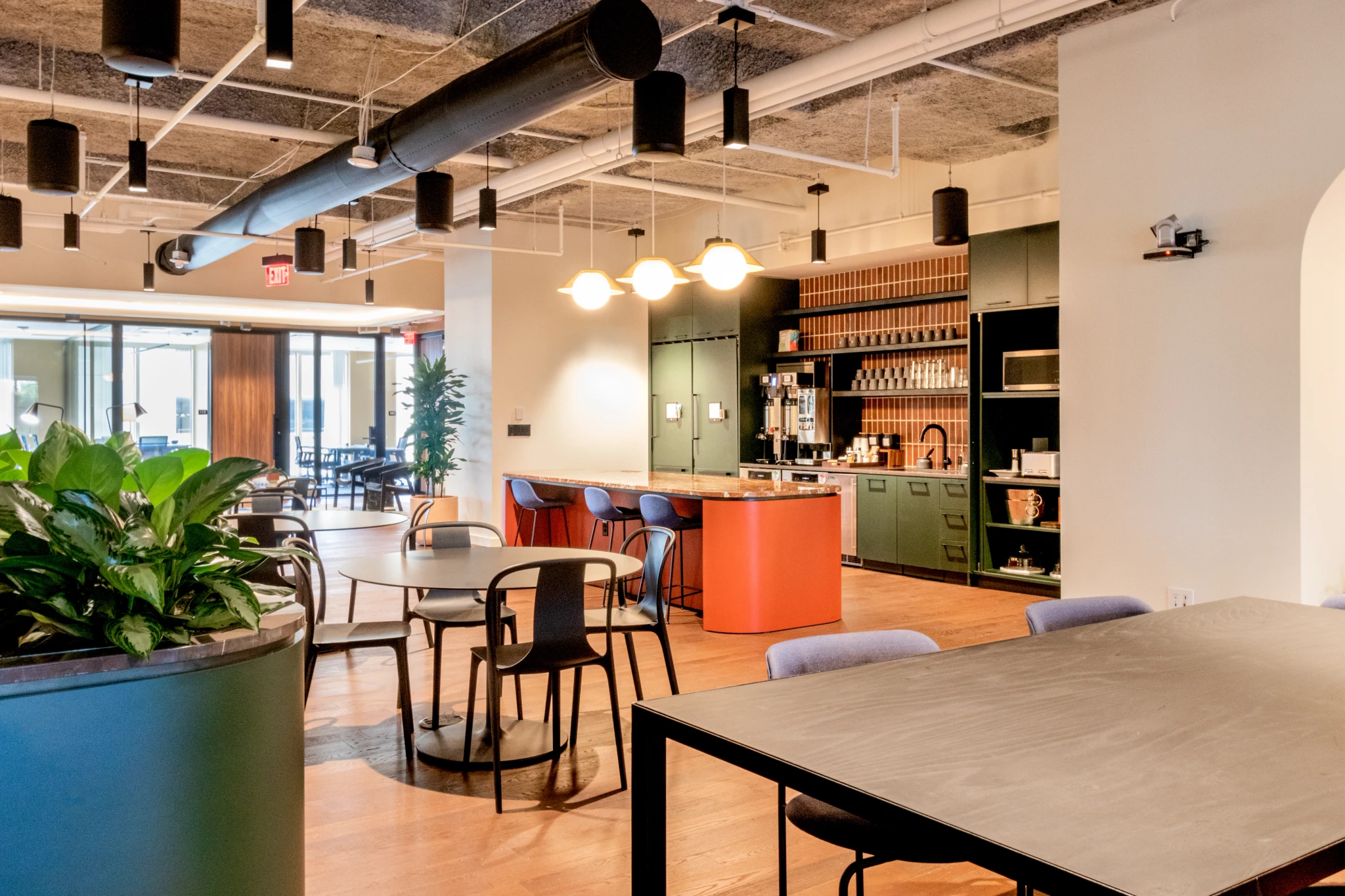 A contemporary workspace with tables and chairs.
