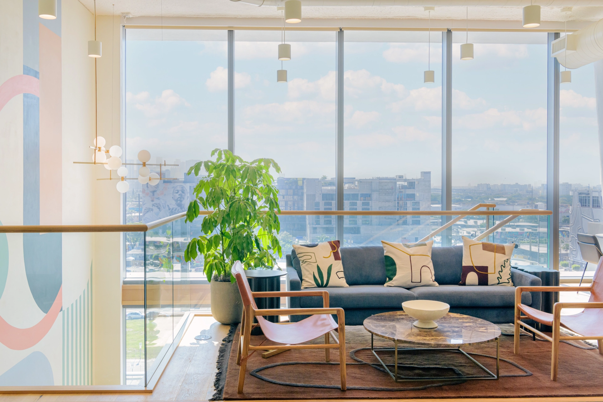 a workspace with a large window overlooking a city.