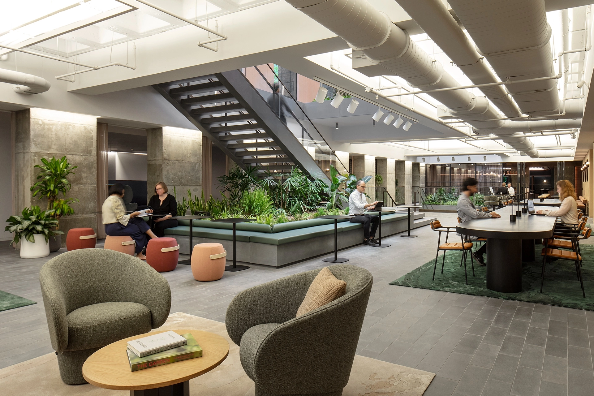 A rendering of an office lobby with people sitting in a meeting room.