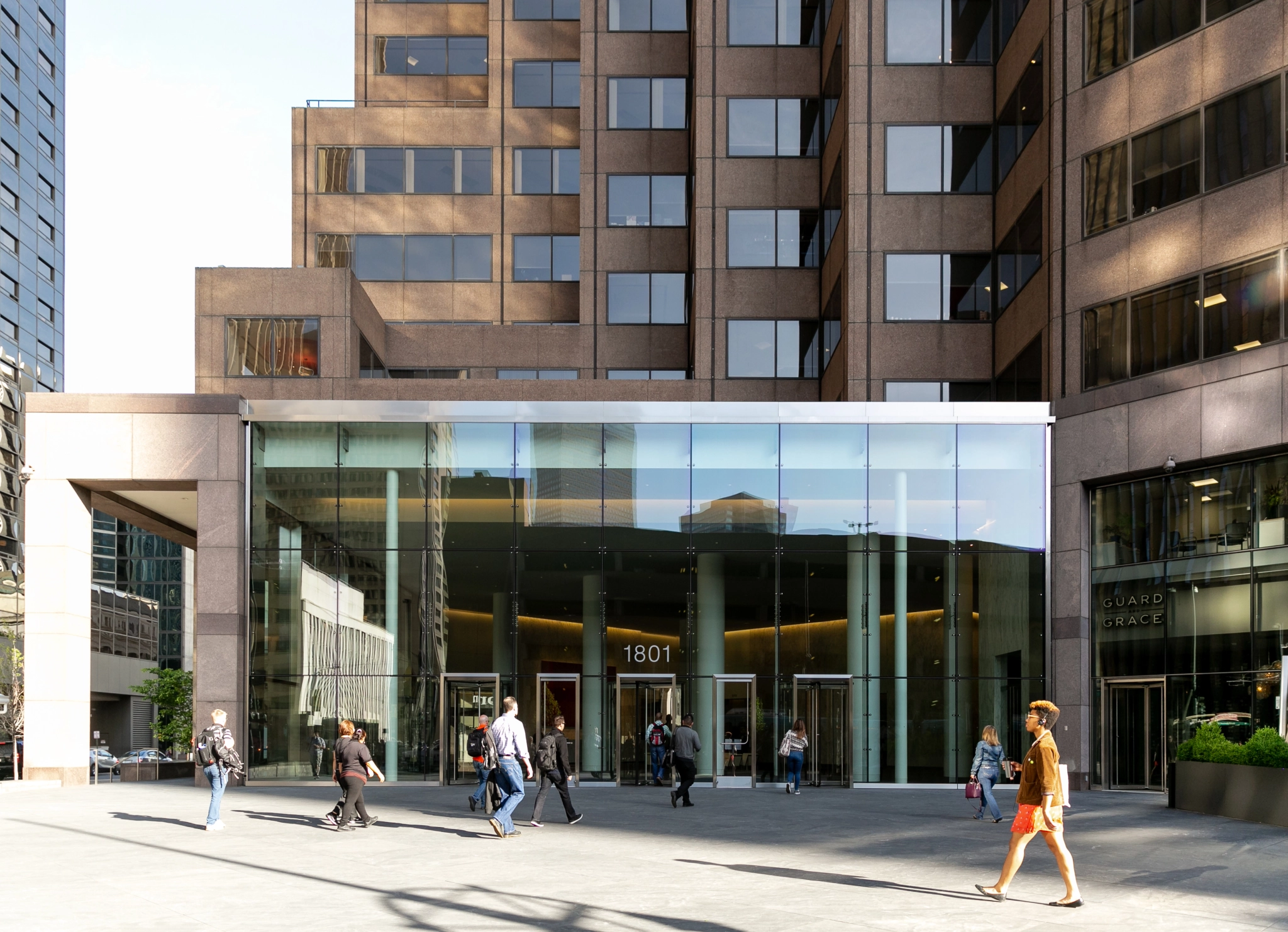 People walking in front of an office building.