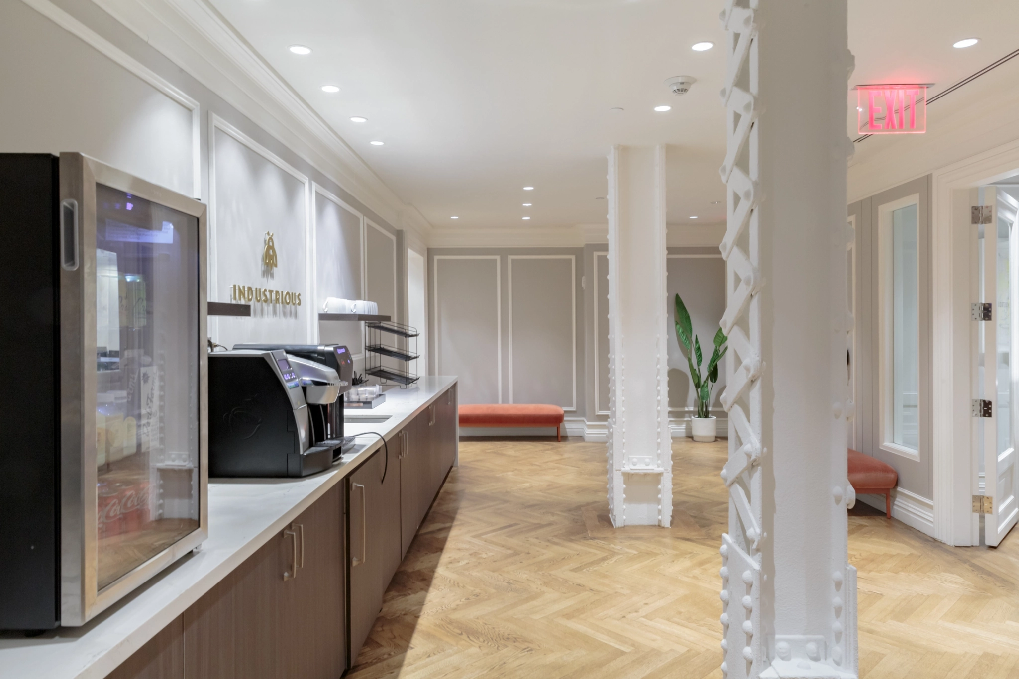 A workspace hallway equipped with a coffee machine and a refrigerator.