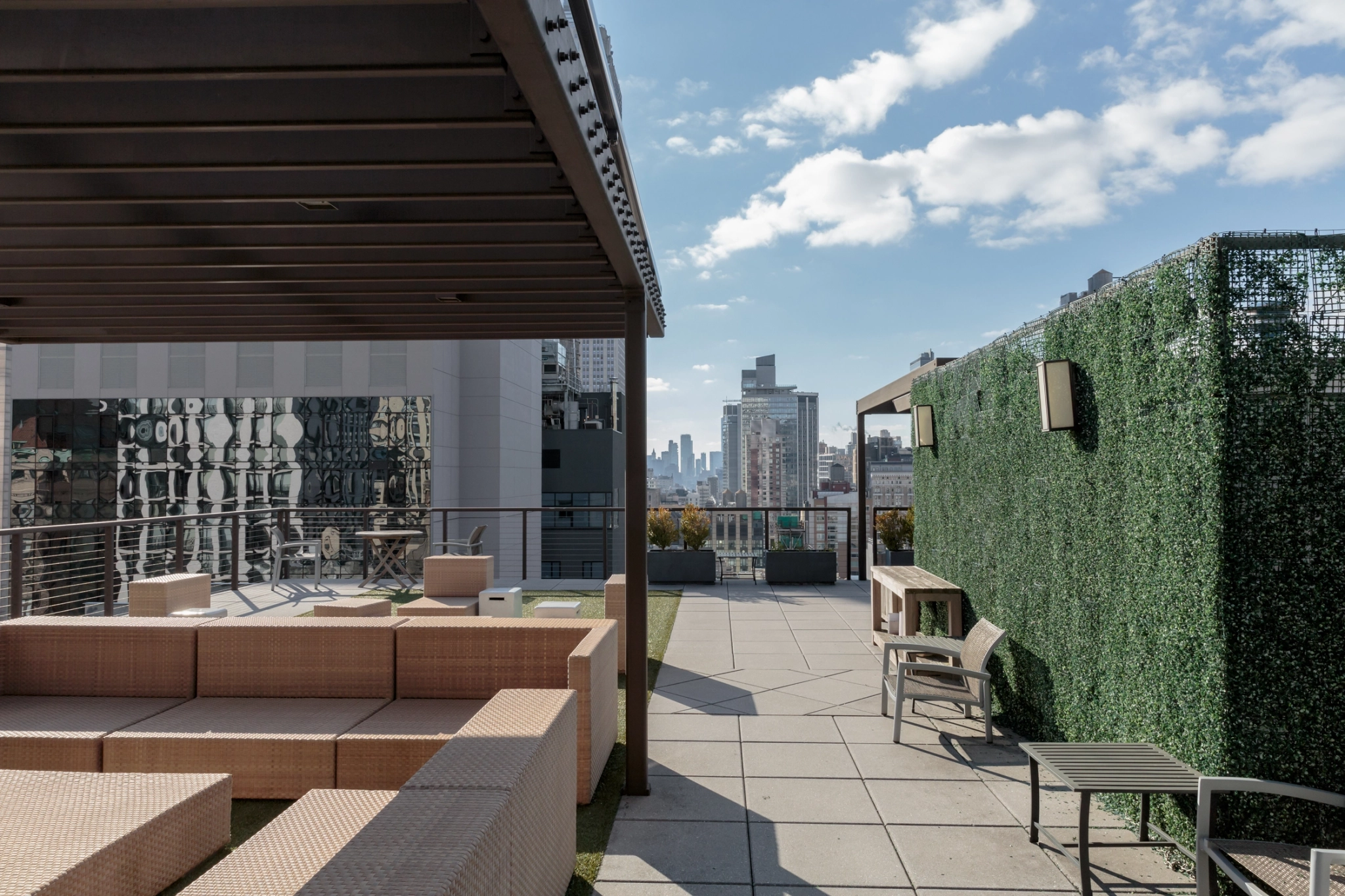 A rooftop office workspace in New York with seating and a city view.