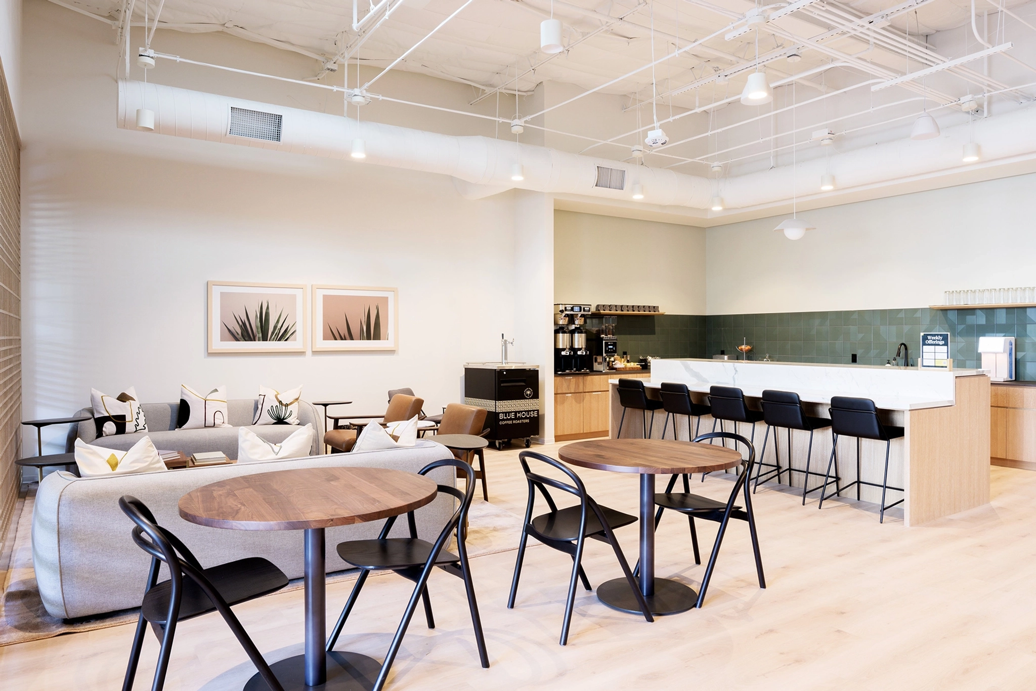 A large open space with tables and chairs for meetings.