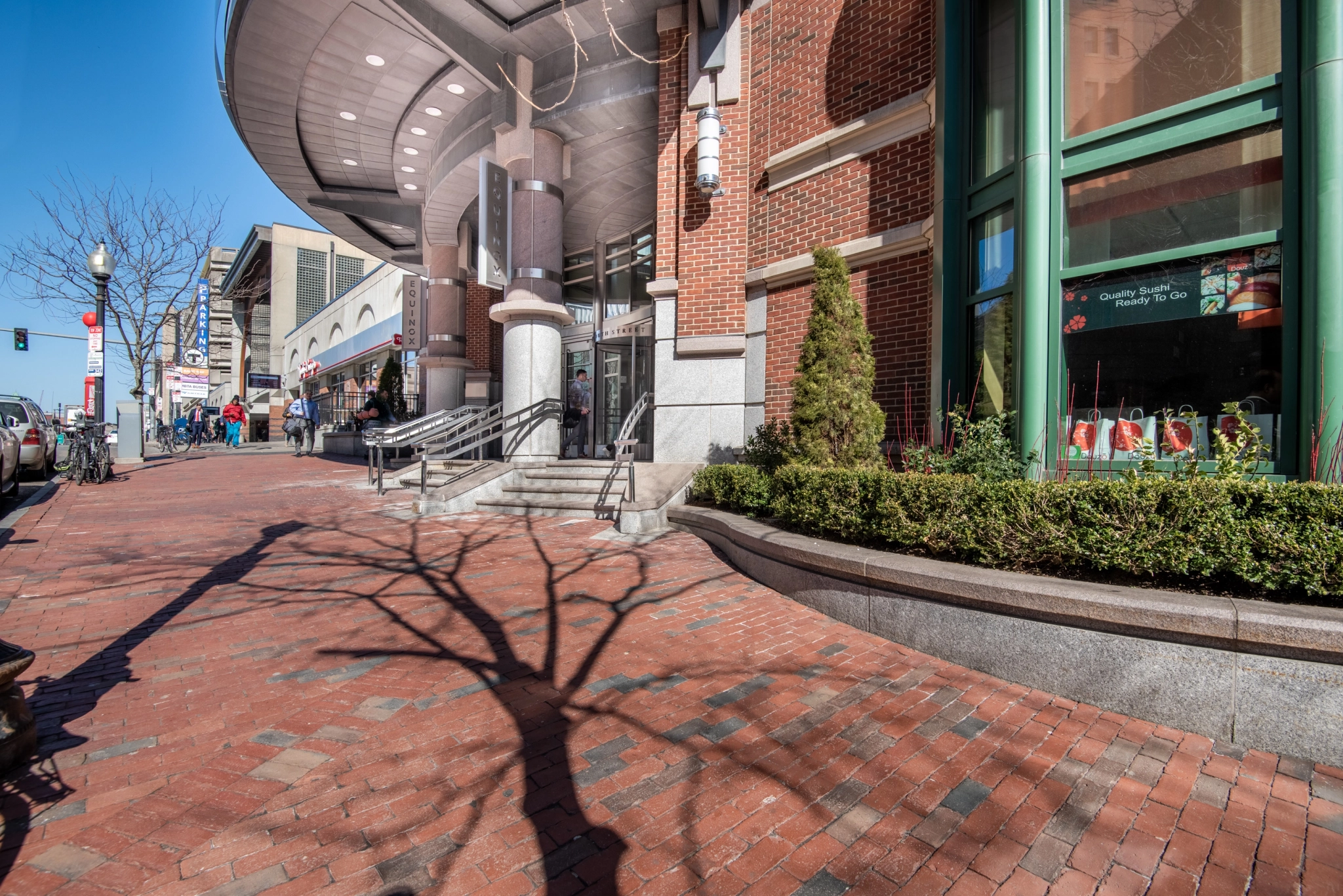 a brick sidewalk in front of a store that could serve as an outdoor workspace or meeting room.