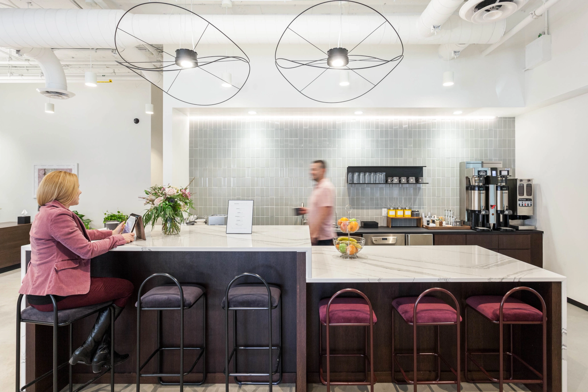 Keywords: office, coworking

Description: A woman sits at a counter in a coworking office.