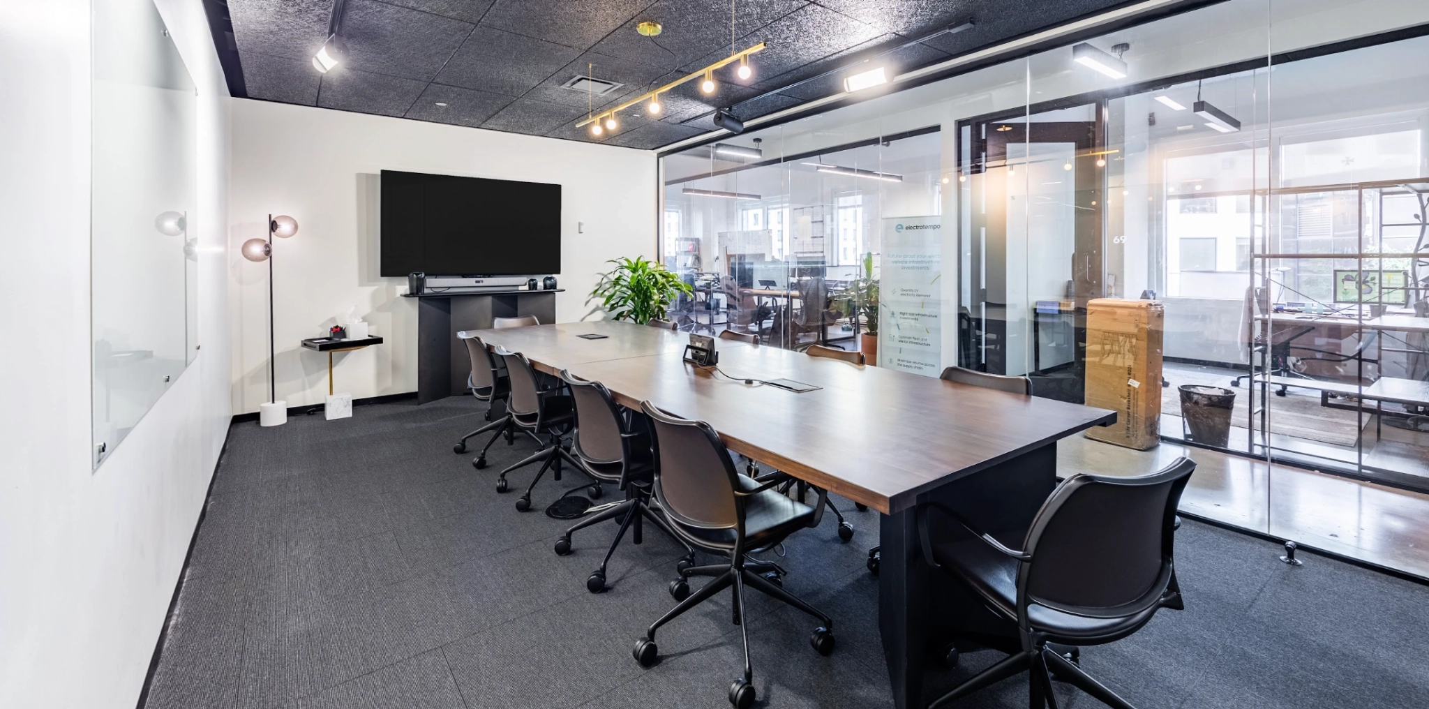 Large meeting room with AV system, white board, 10 chairs, neat bar system and glass panels for natural light