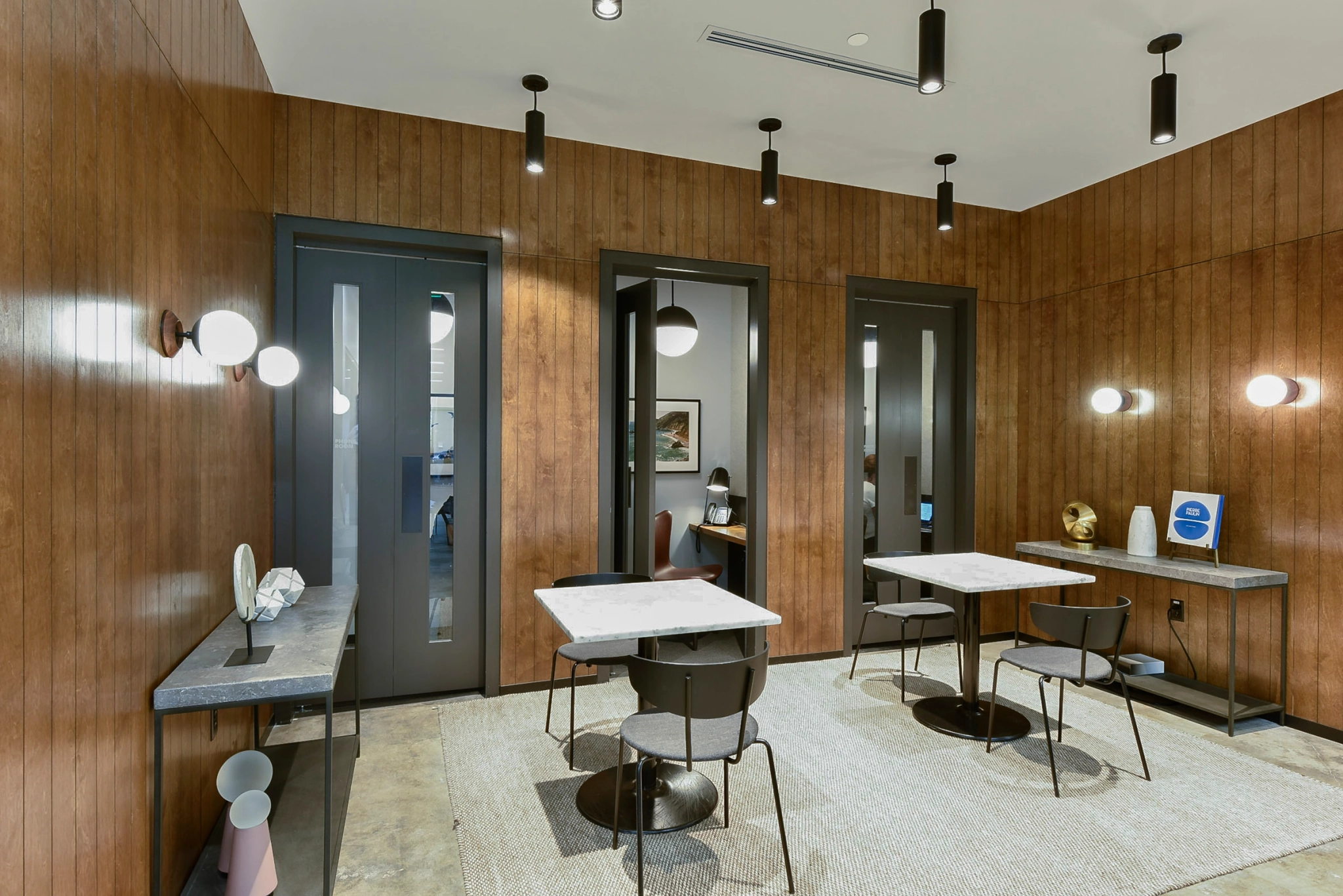 A coworking office in Atlanta furnished with wooden walls and a table and chairs.