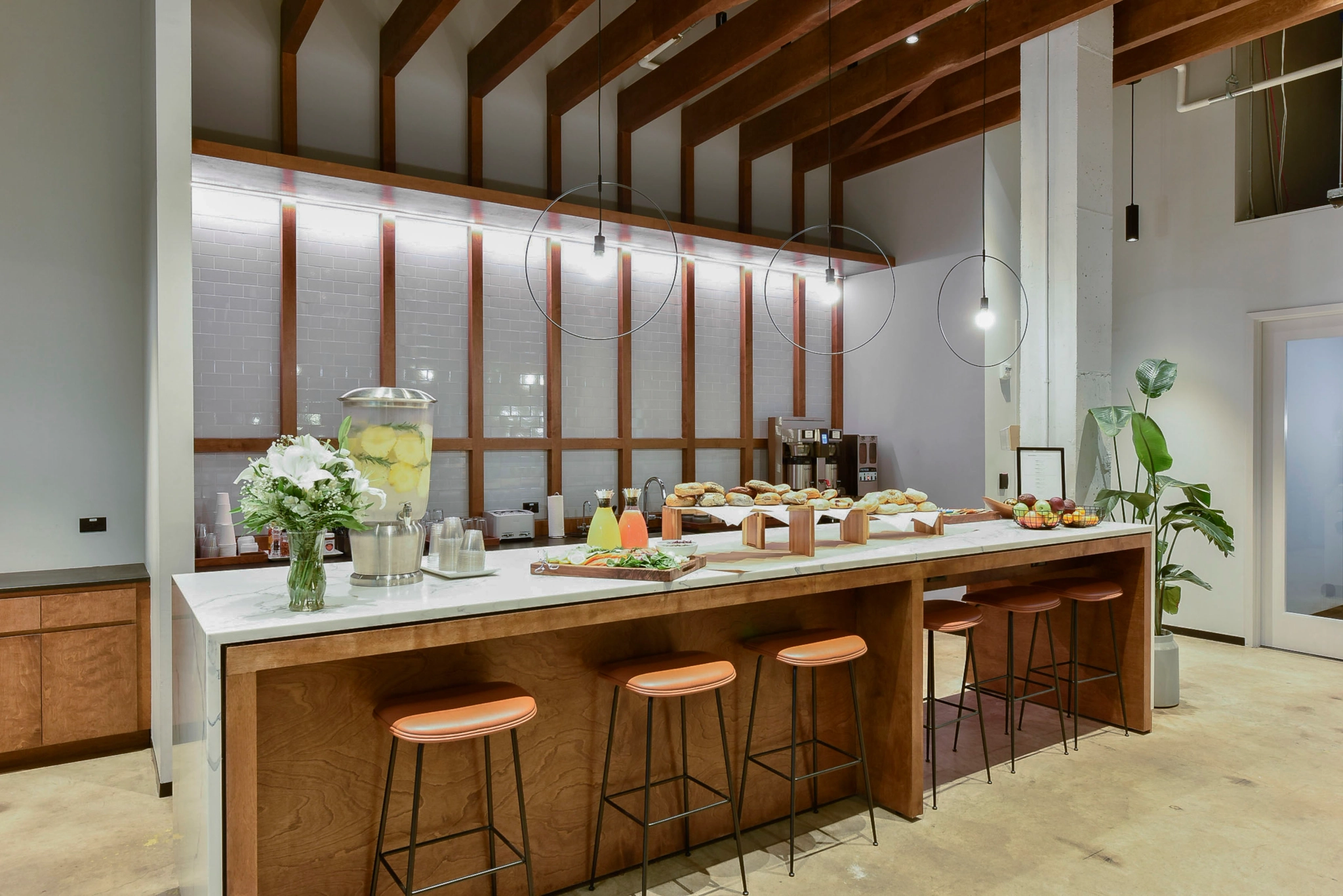 an open kitchen with stools and a bar, perfect for coworking in Atlanta.